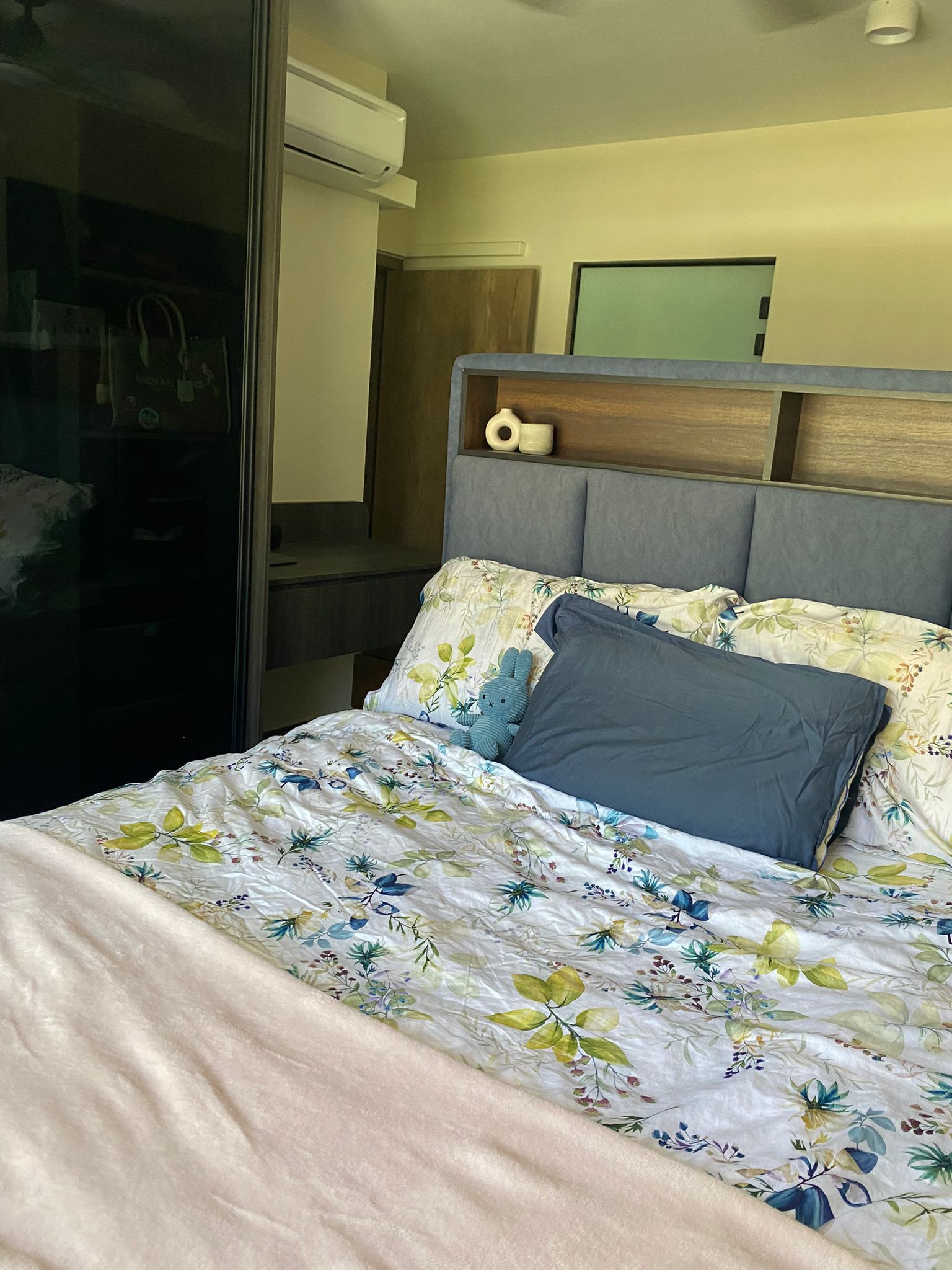 Integrating sleep and play for a space constrained 4-room BTO - Floral-patterned bedspread, blue pillow, beige blanket
