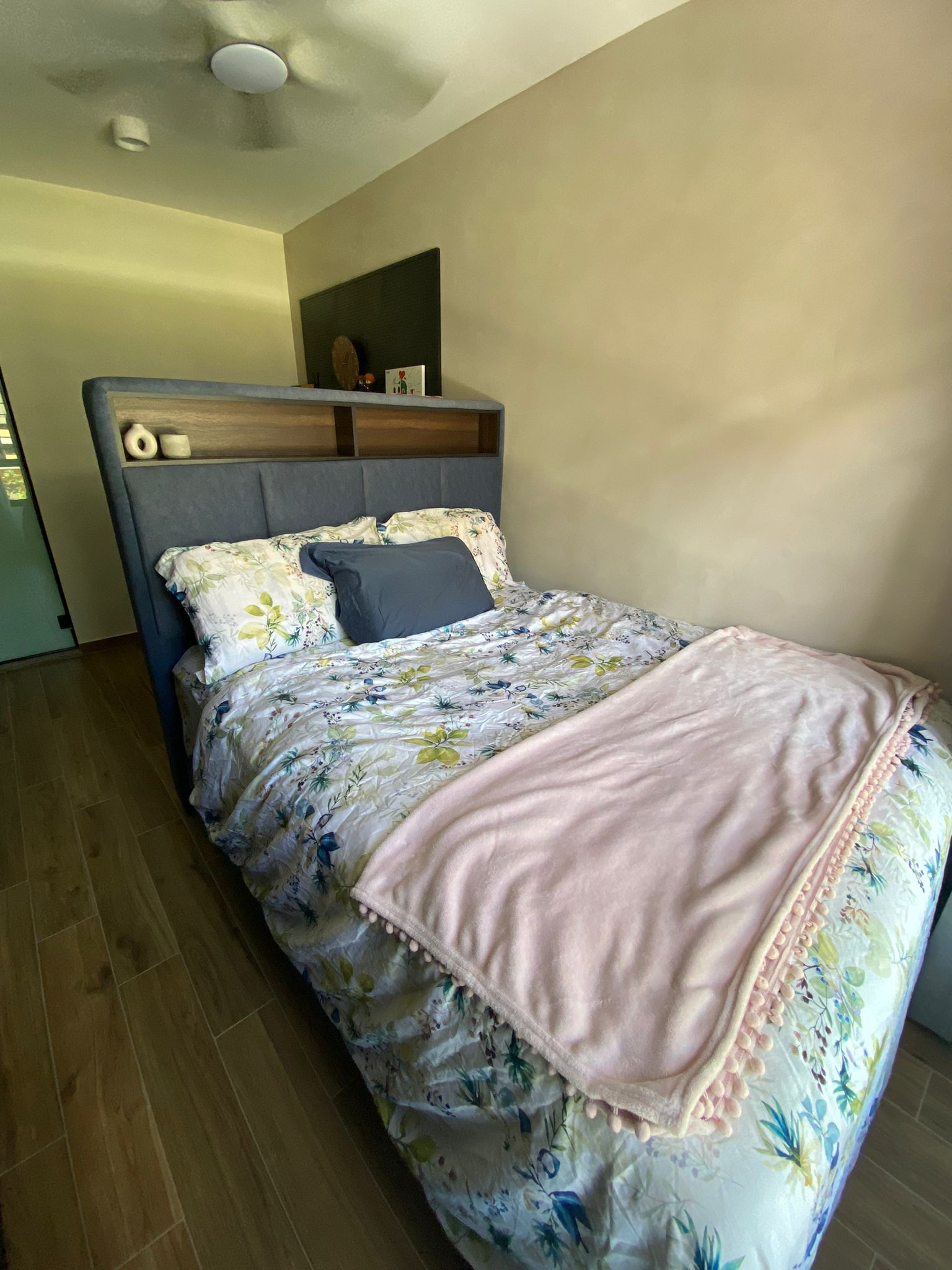 Integrating sleep and play for a space constrained 4-room BTO - Floral-patterned bedspread, light blue upholstered headboard