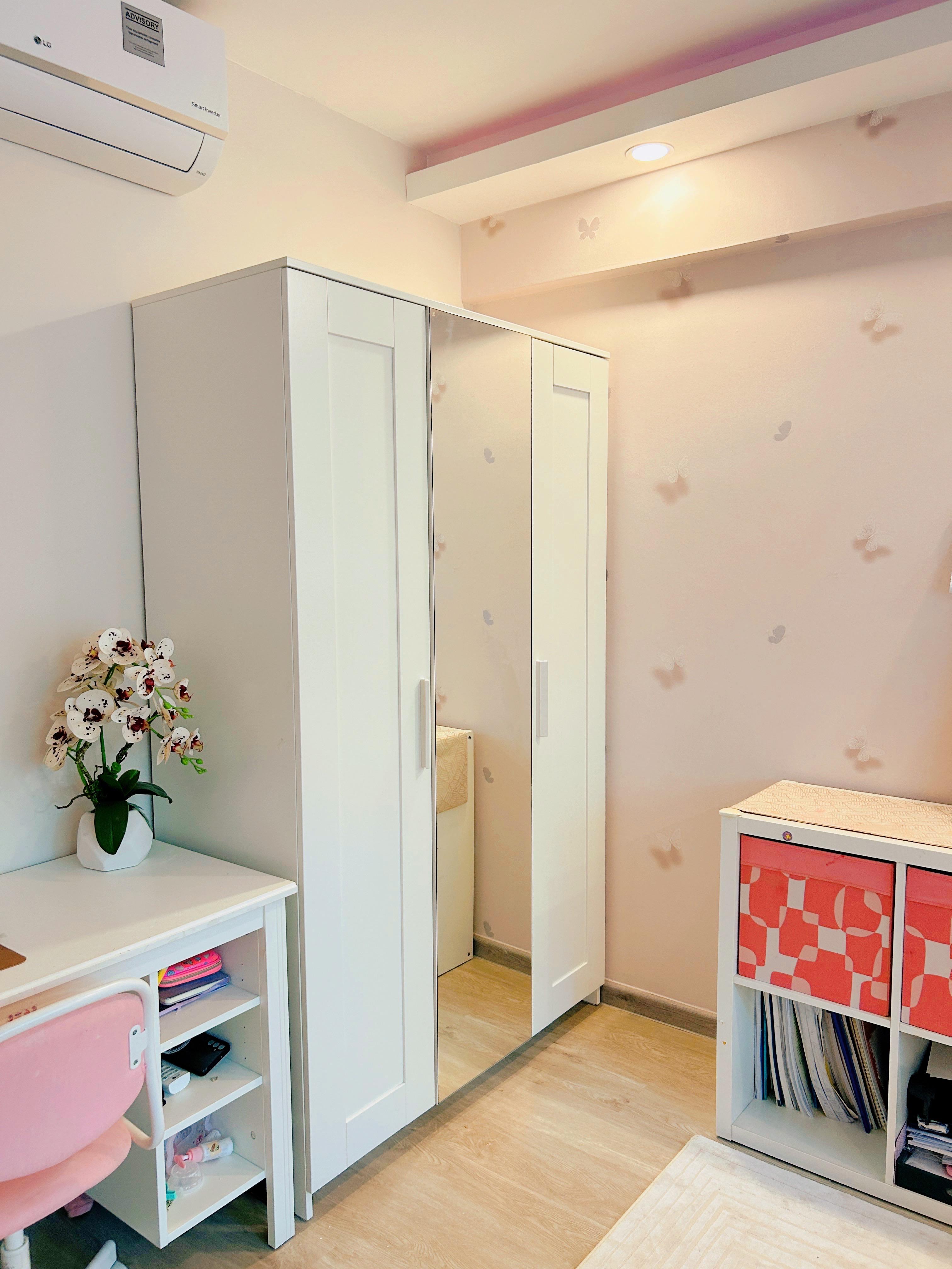 Pink Paradise: A Tour of Our Kids’ Dream Room! - White wardrobe with mirrored doors, pink chair, white desk with orchid