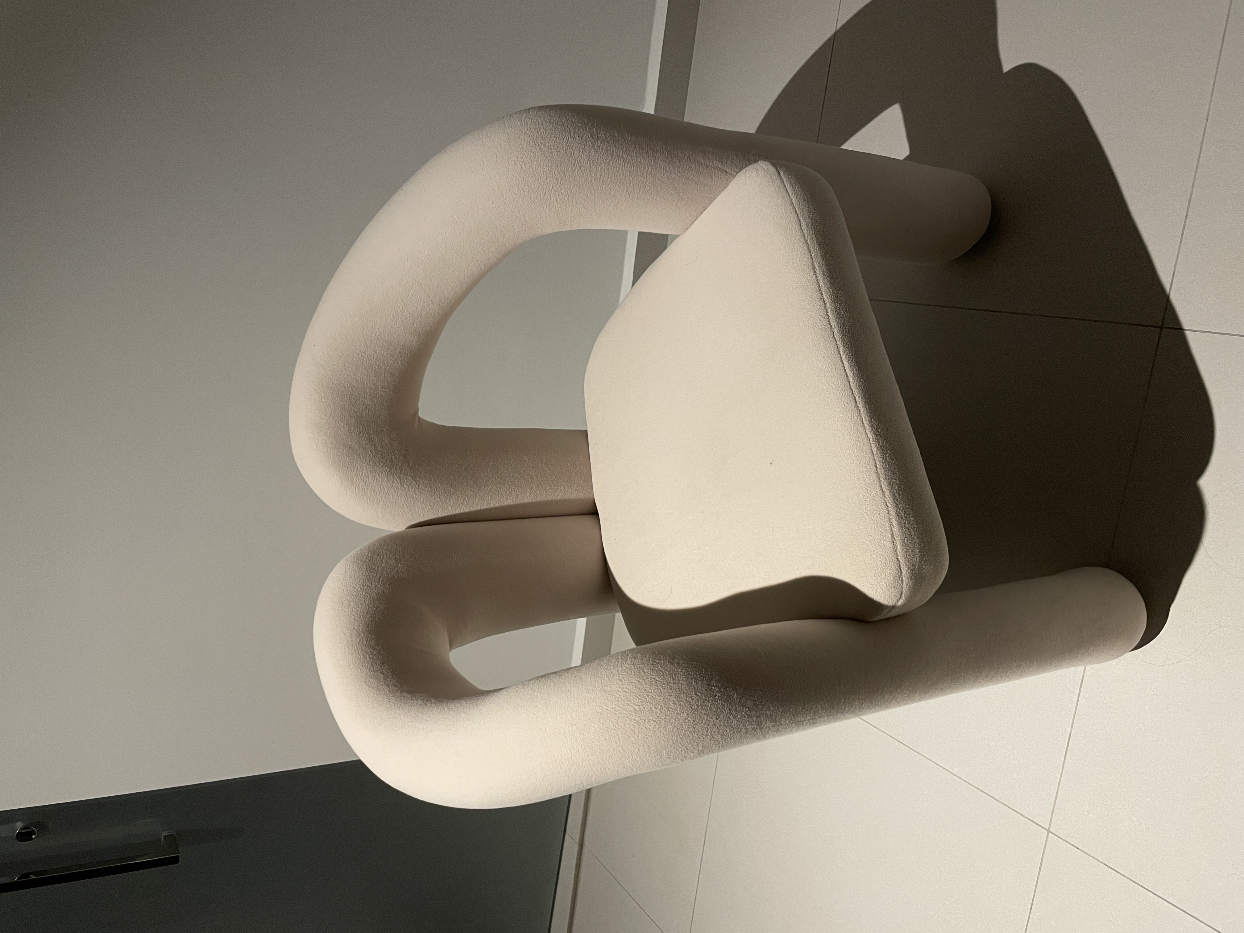 A Bedroom Haven: Curved Platform Bed with Plenty Wardrobe Spaces  - Modern minimalist chair, soft beige upholstery, geometric