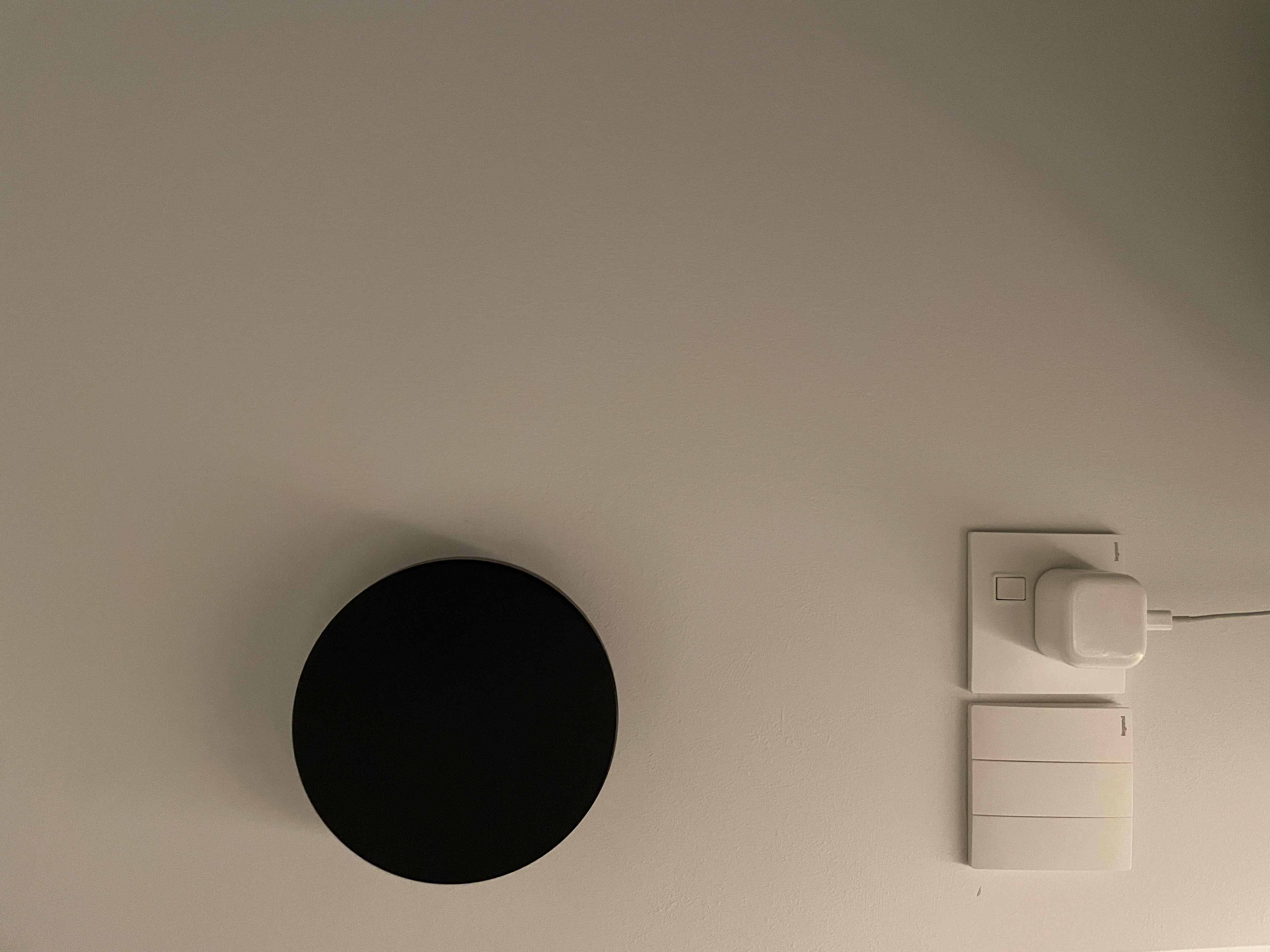 A Bedroom Haven: Curved Platform Bed with Plenty Wardrobe Spaces  - Wall-mounted black circular object, minimalist design