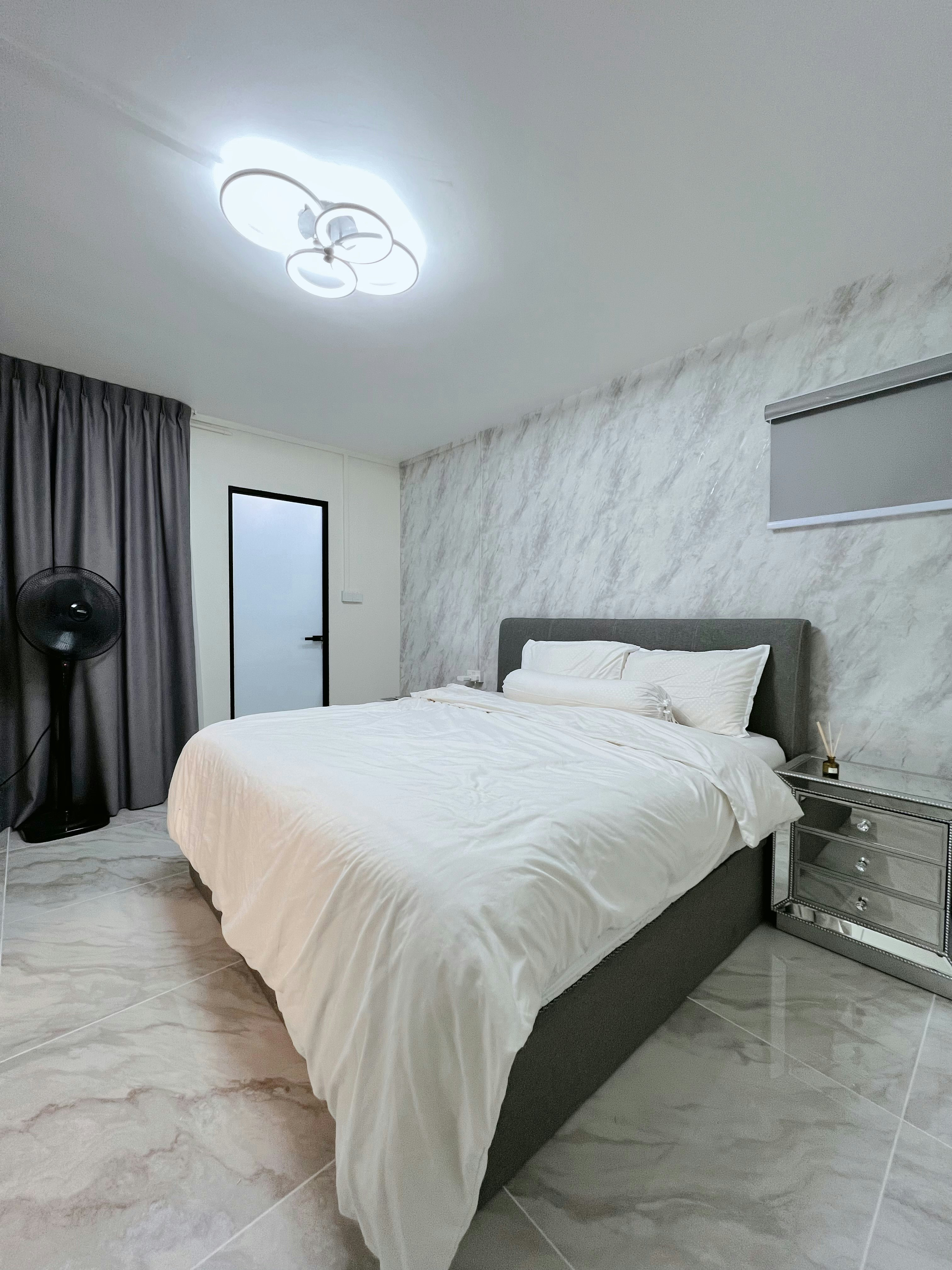 The Master Bedroom: Peaceful nights and bright mornings start here!  - Modern bedroom with gray headboard, white bedspread