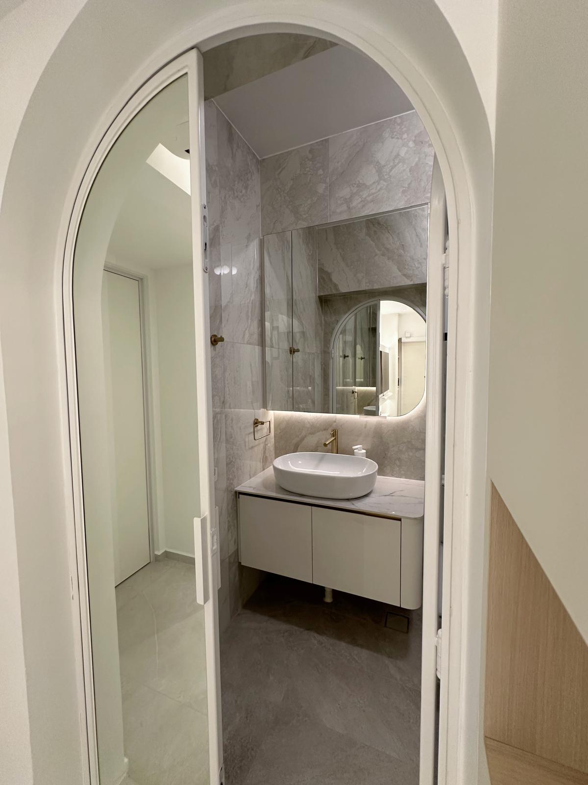 Our Master Bedroom: Smart, Calming & Curvy (with a mirror-ed door!) - Modern bathroom with sleek design, marble tiles, large