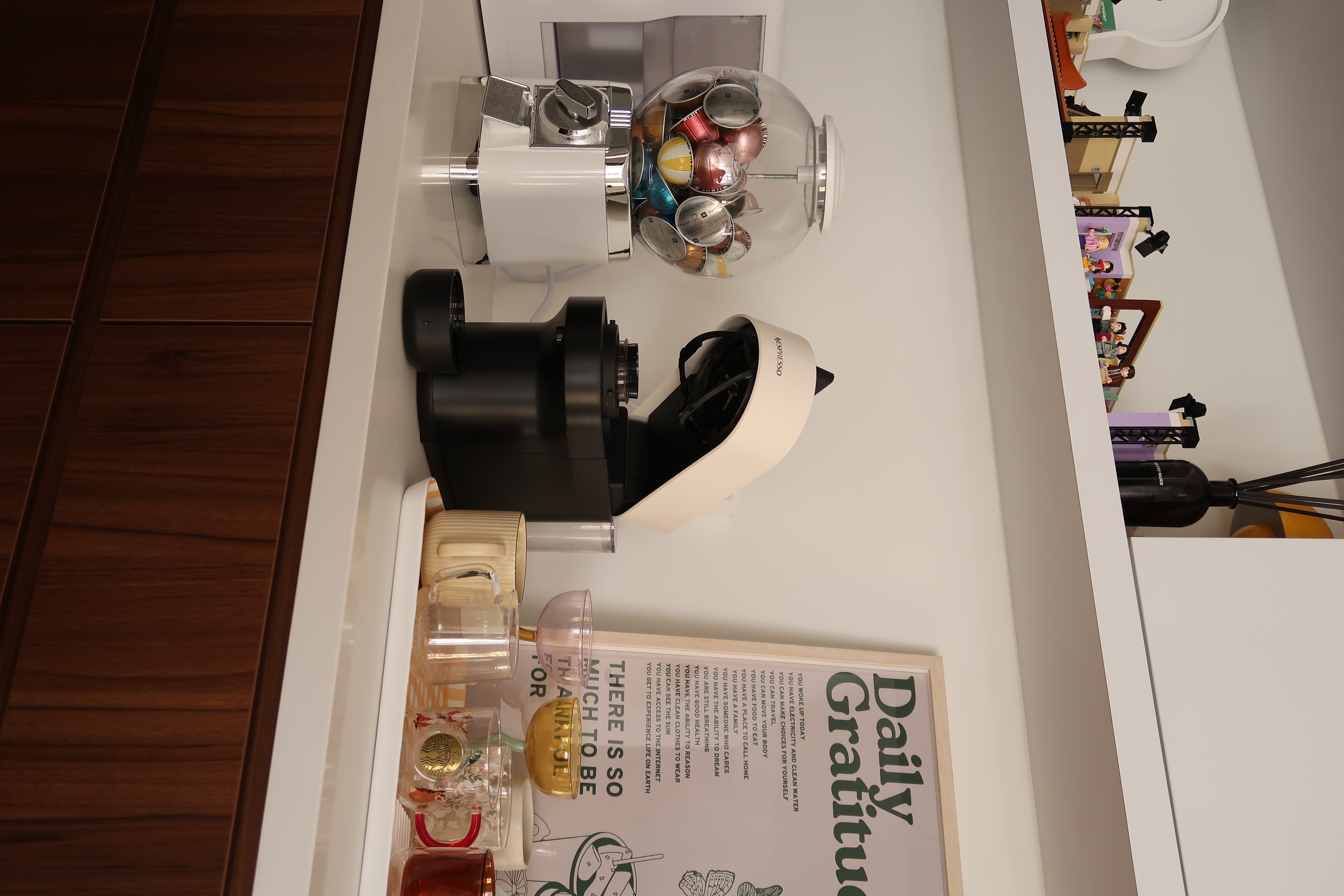 We designed our haus to fit homebodies' weekend routine - Wooden floor, white cabinet, black and white camera, colorful pens