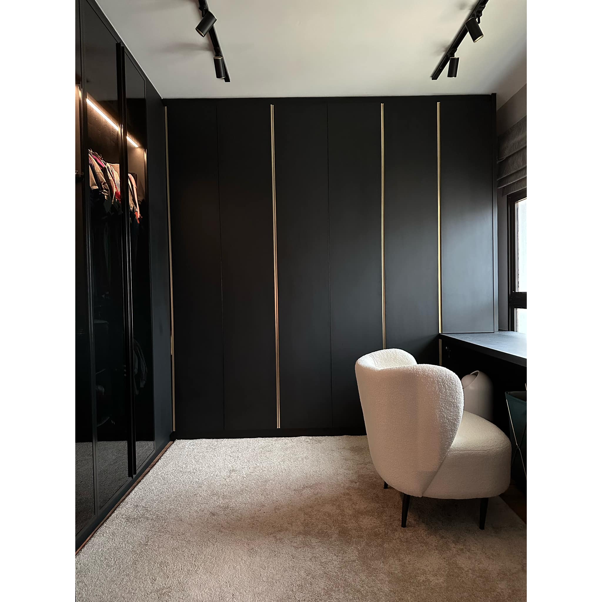 A Modern-luxe Haven, An Elegant Retreat - Modern minimalist wardrobe with sleek black doors and gold accents, sleek black