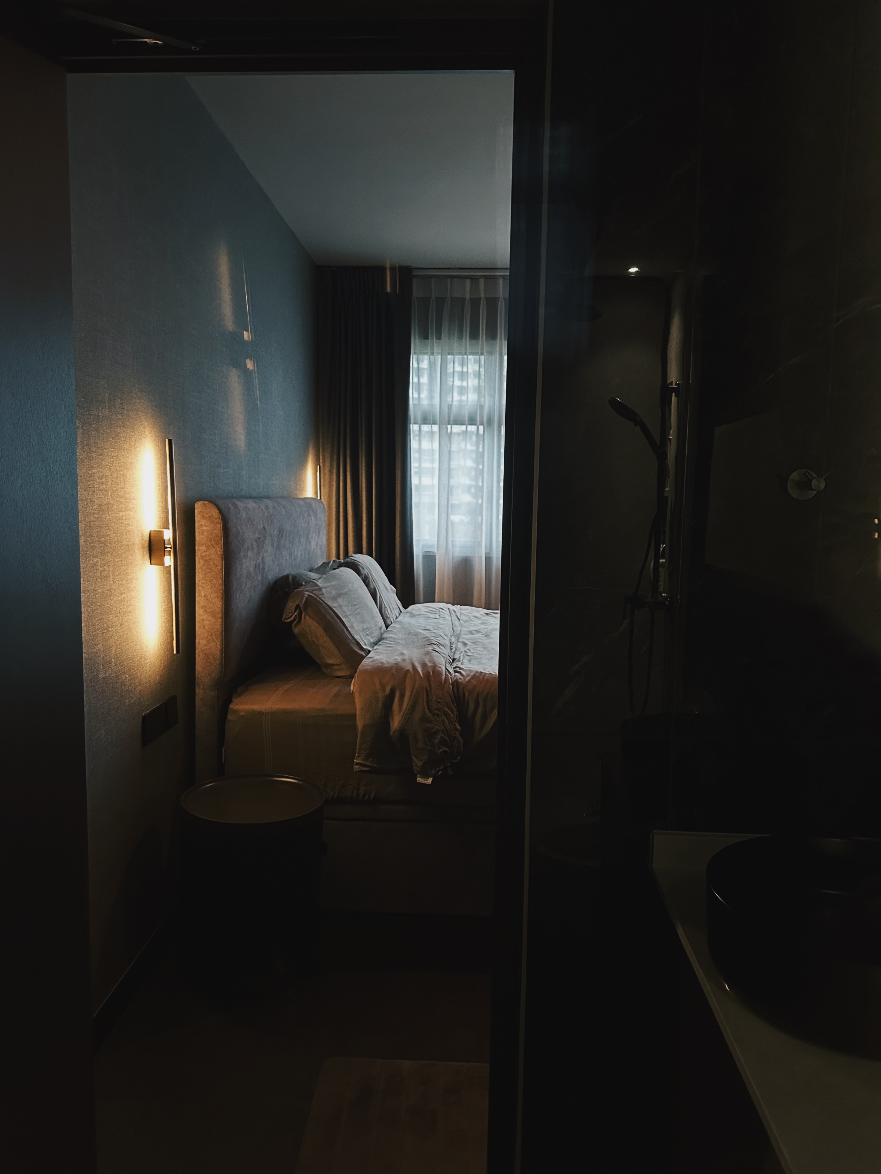 Finding Comfort: A Glimpse into Our Cozy and Minimalist Bedroom - dimly lit bedroom, modern decor, cozy atmosphere, soft