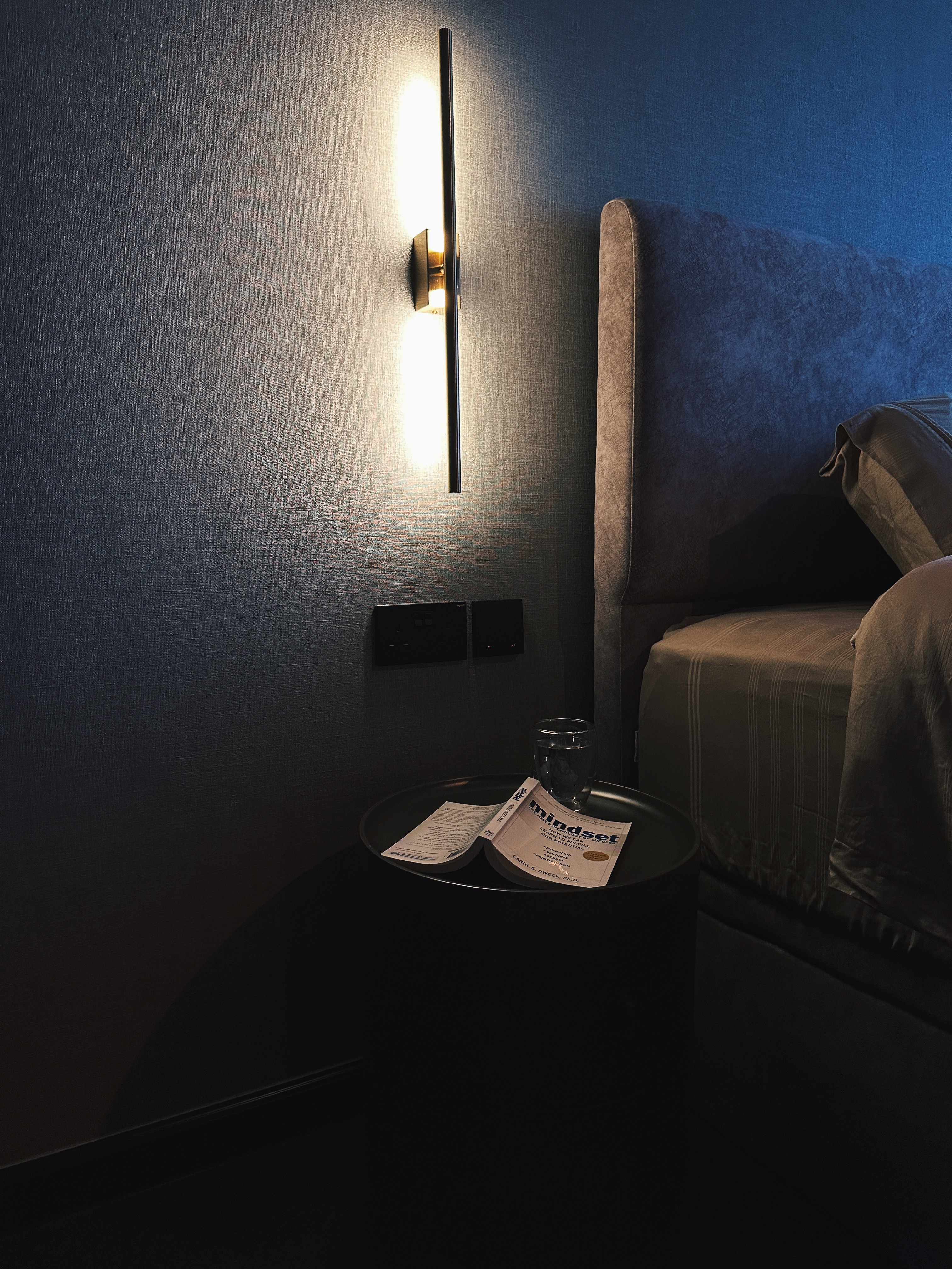 Finding Comfort: A Glimpse into Our Cozy and Minimalist Bedroom - modern bedroom, cozy corner, soft lighting, textured wall