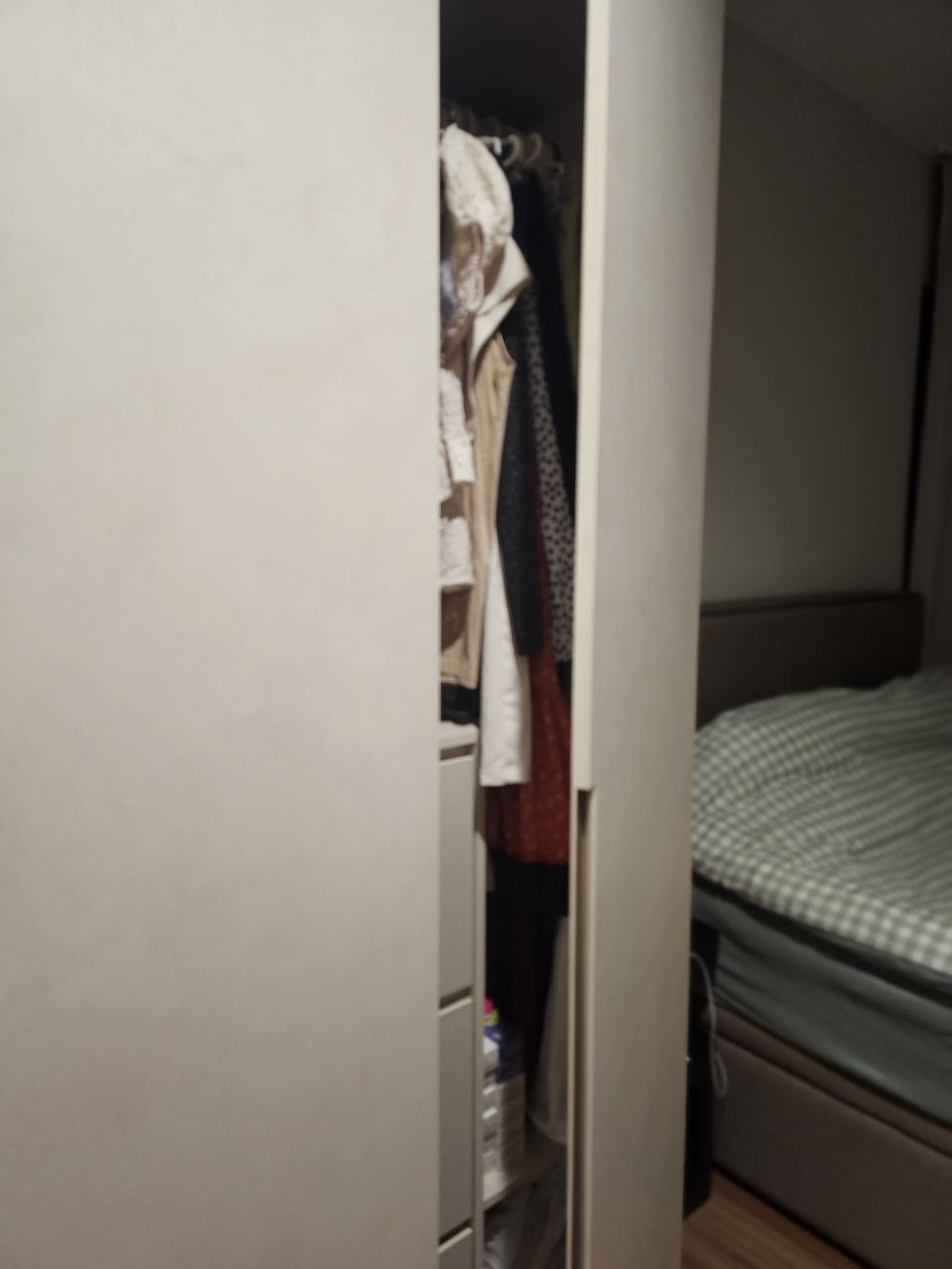 Simple living - prioritizing function and convenience in our bedroom - Clothes hanging in closet, wardrobe door open, clothes