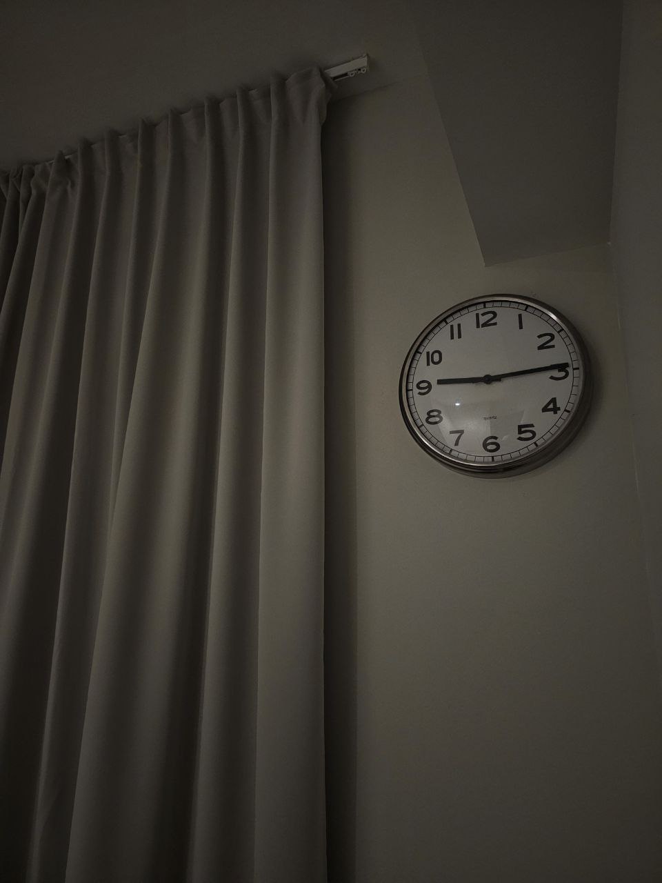 Simple living - prioritizing function and convenience in our bedroom - Elegant wall clock with black numbers and hands, set