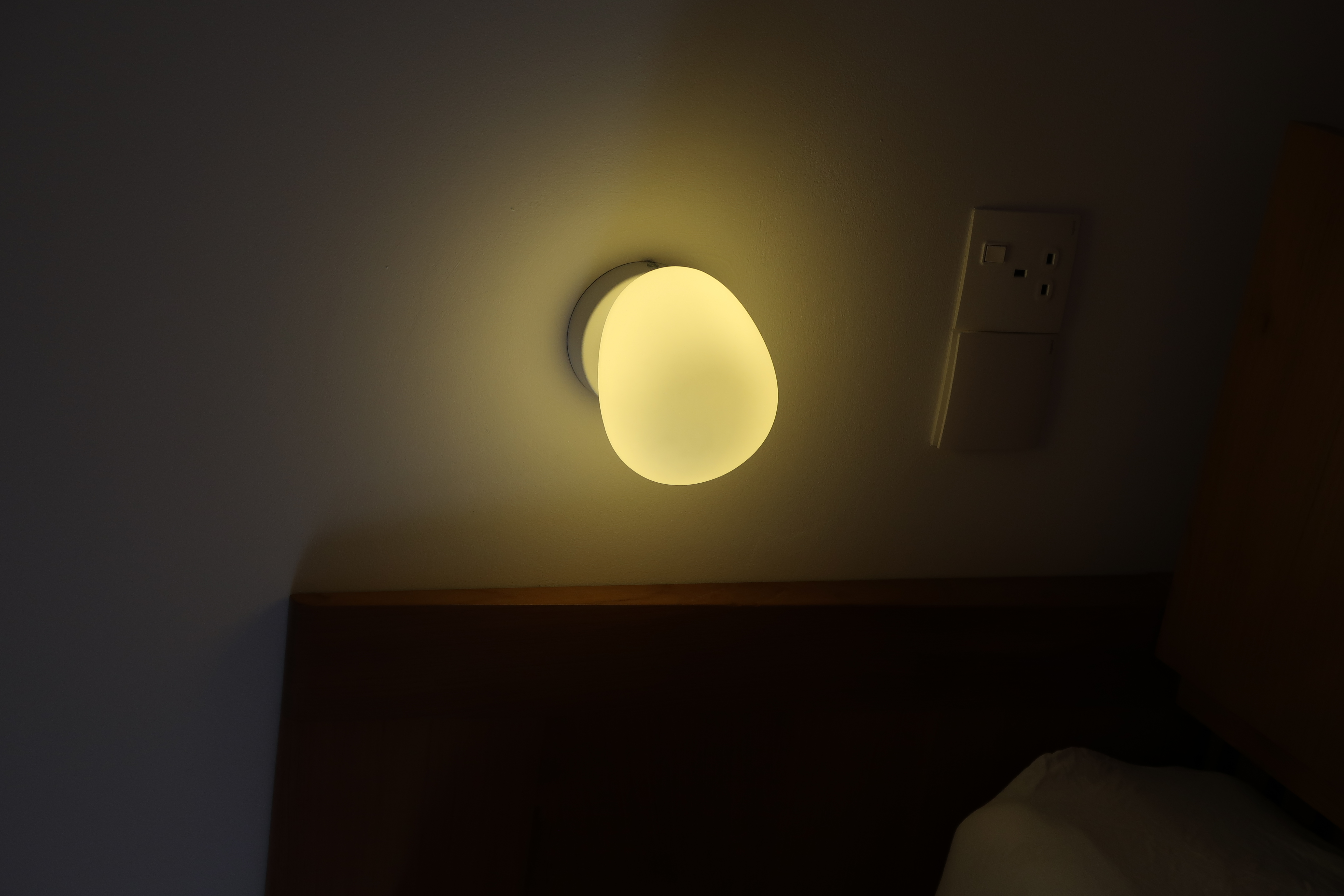Master Bedroom: A Peaceful Retreat - Soft, warm glow emanates from a modern, round ceiling light fixture., The light fixture