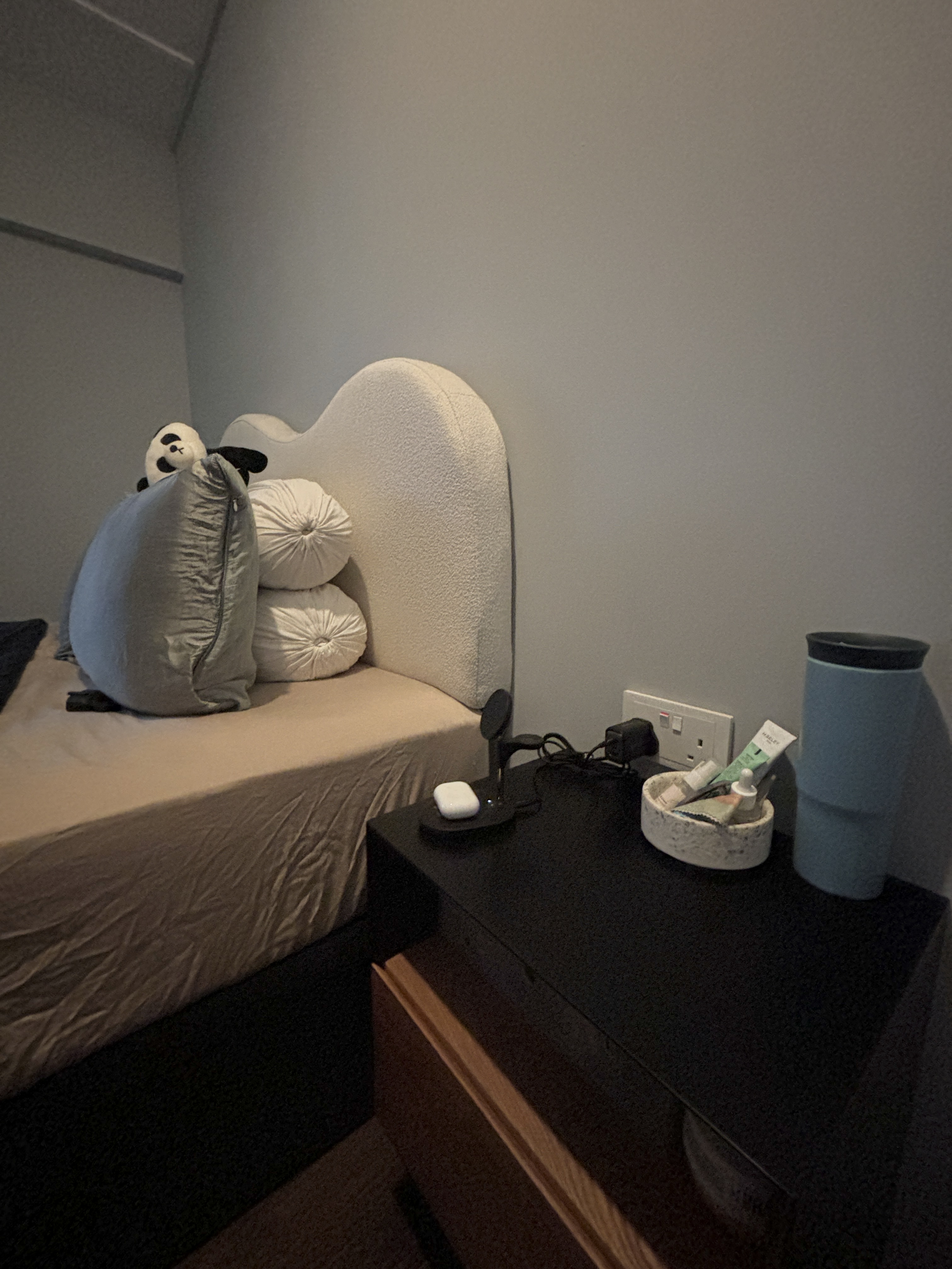 Transforming Our Bedroom from Minimal to Cosy  - bed with plush panda toy, beige and gray pillows, modern bedside table