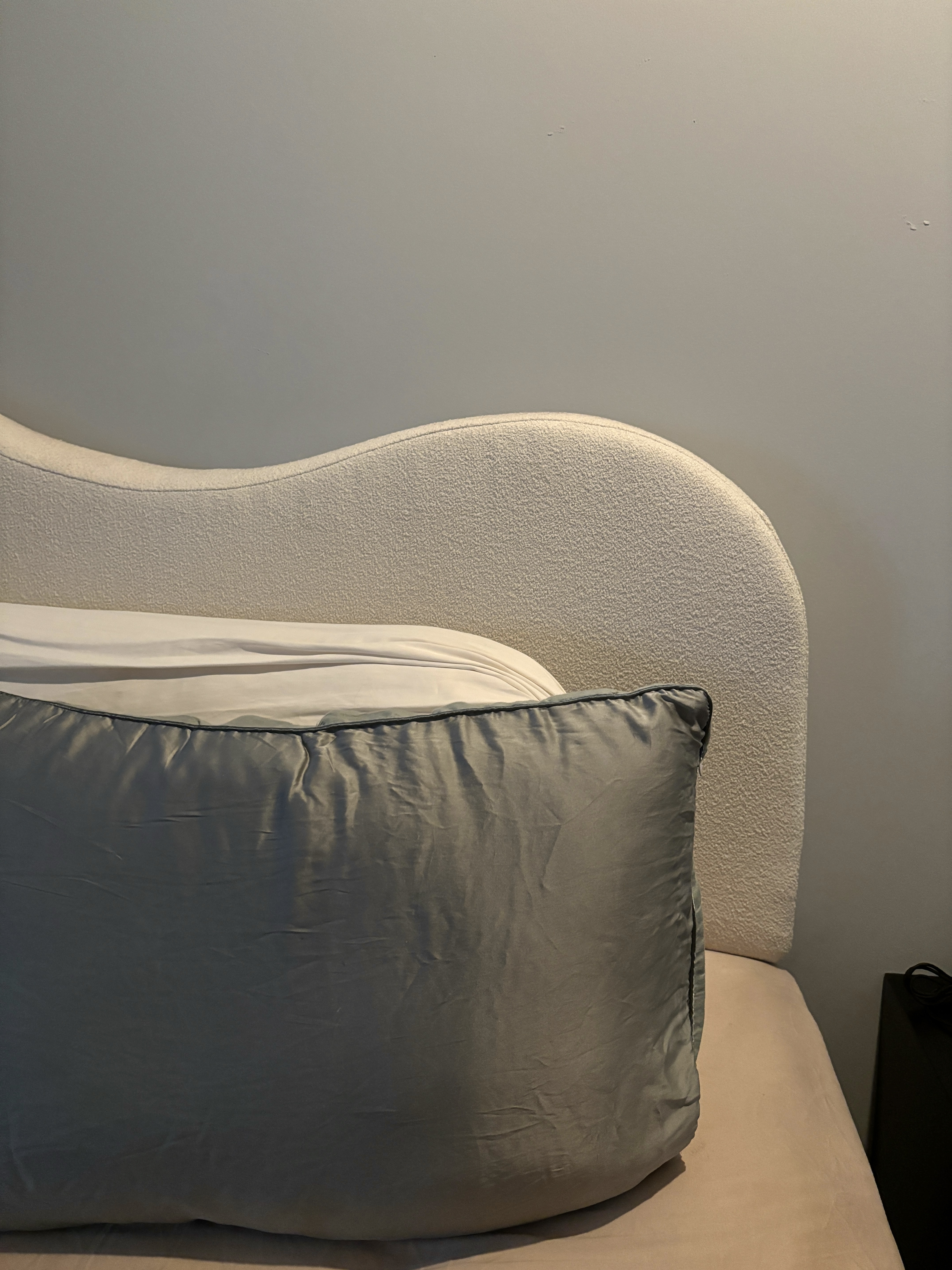 Transforming Our Bedroom from Minimal to Cosy  - Cream upholstered headboard, soft beige bedspread, gray accent pillow