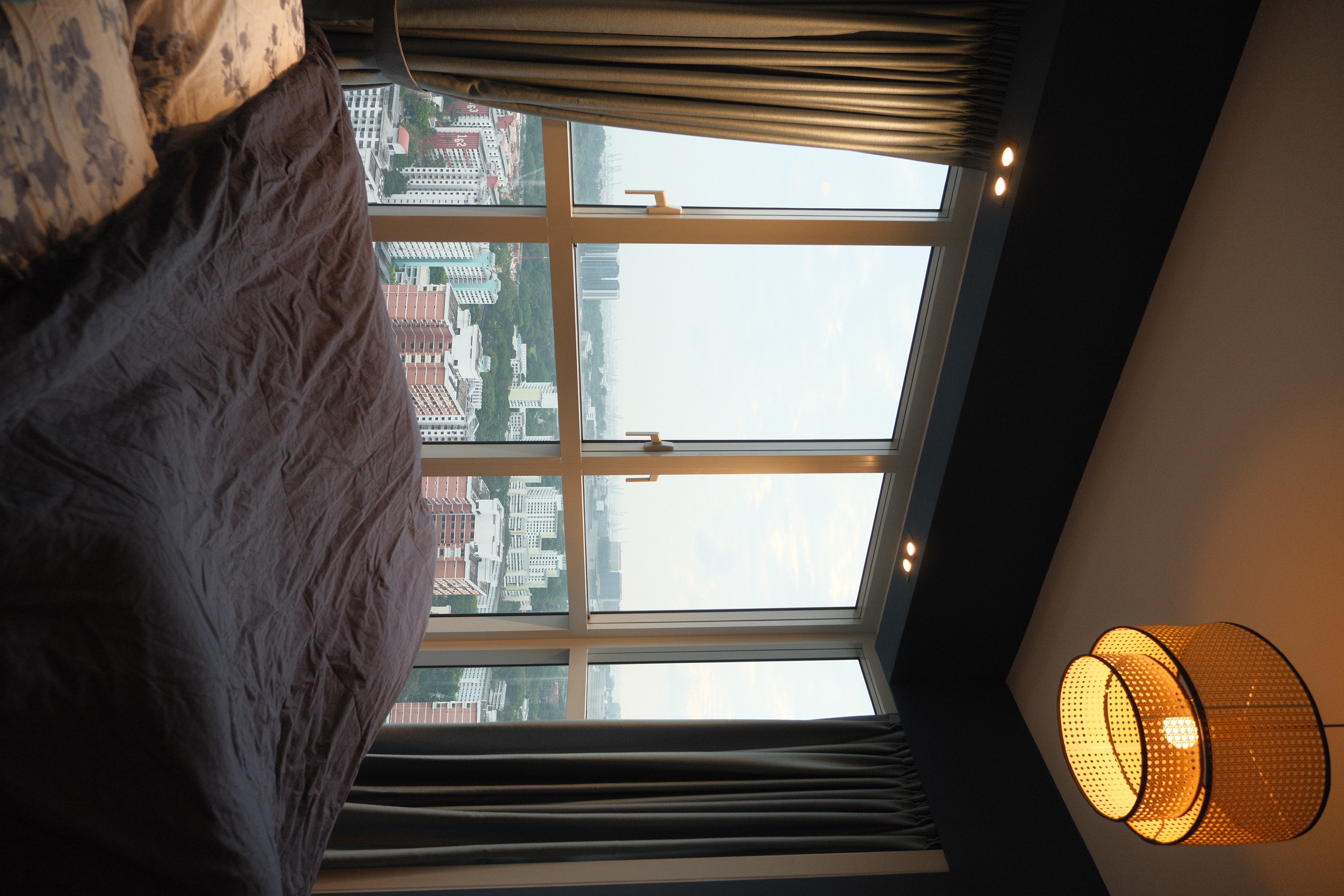 A Modern and Cosy Retreat into the Master Bedroom Hideout - Large window, cityscape, view, tall buildings, ceiling lights