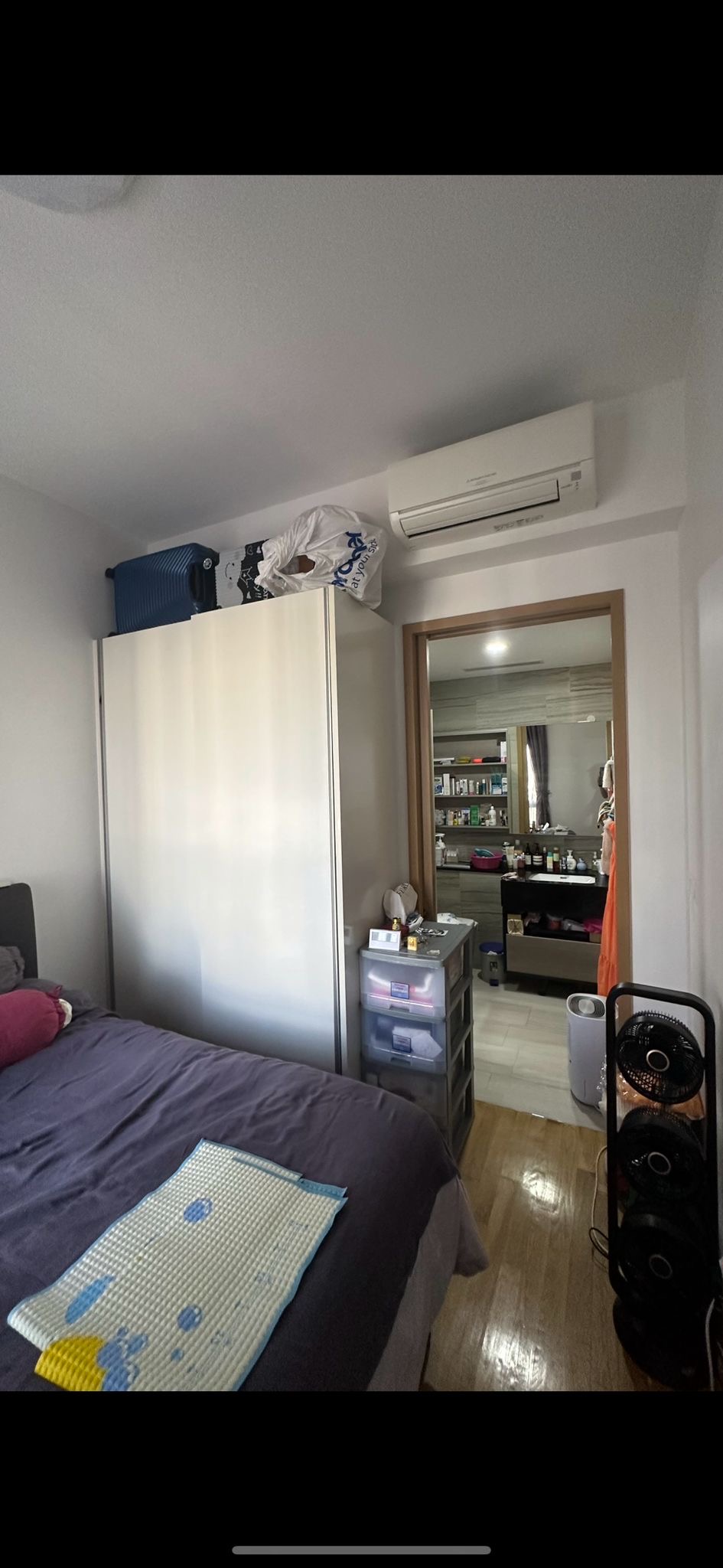 A Minimalistic Bedroom with Plenty of Storage Space  - Compact bedroom with a large bed and a wardrobe, Air conditioning unit