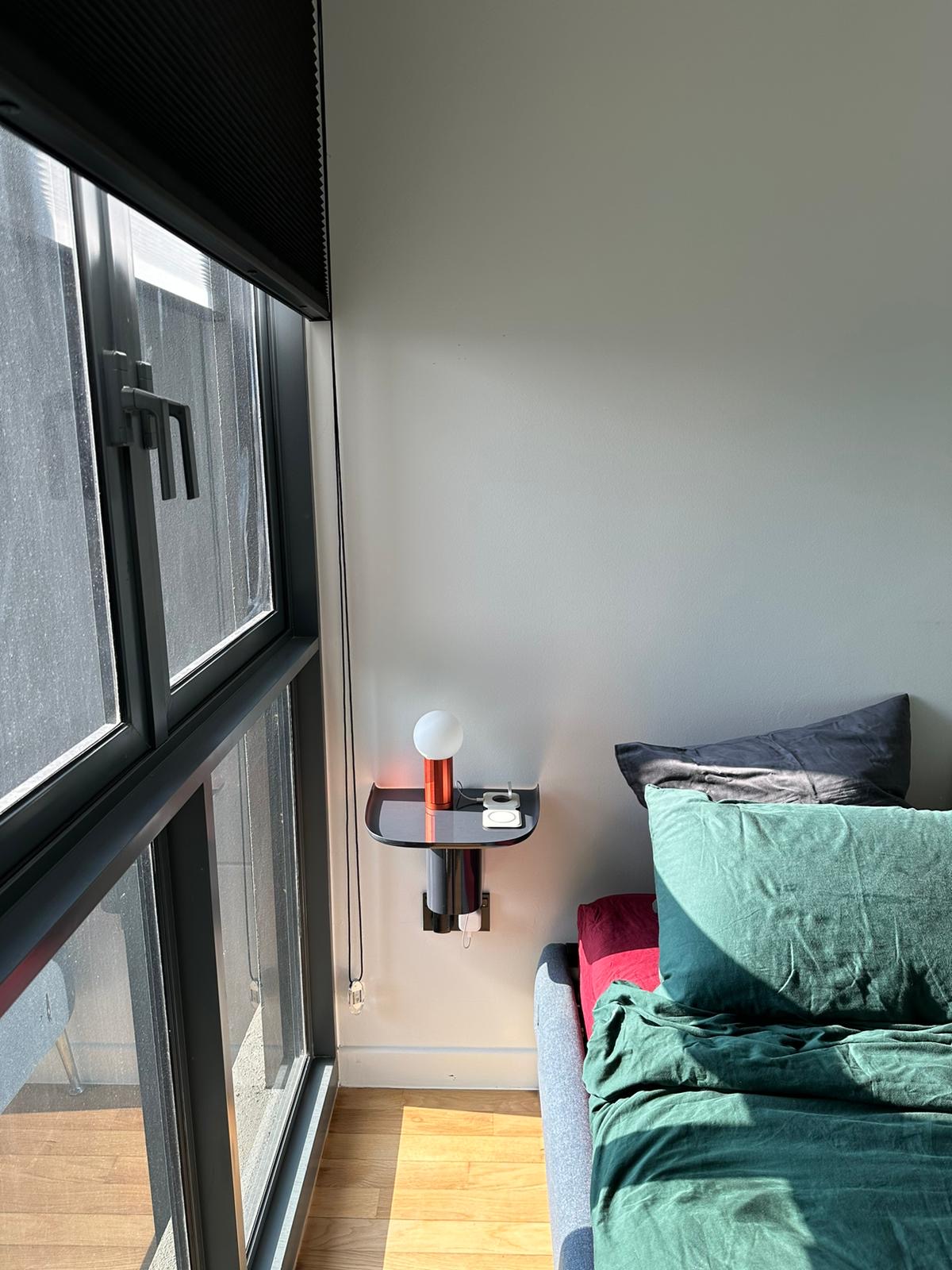 A Minimalistic Bedroom with Plenty of Storage Space  - Large window with black frame, floor-to-ceiling glass doors, natural