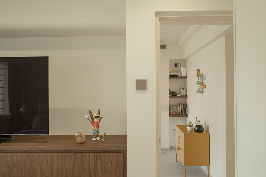 Maximising space in our compact master bedroom  - Wooden TV cabinet, small figurine, cat figurine, toy, small green creature