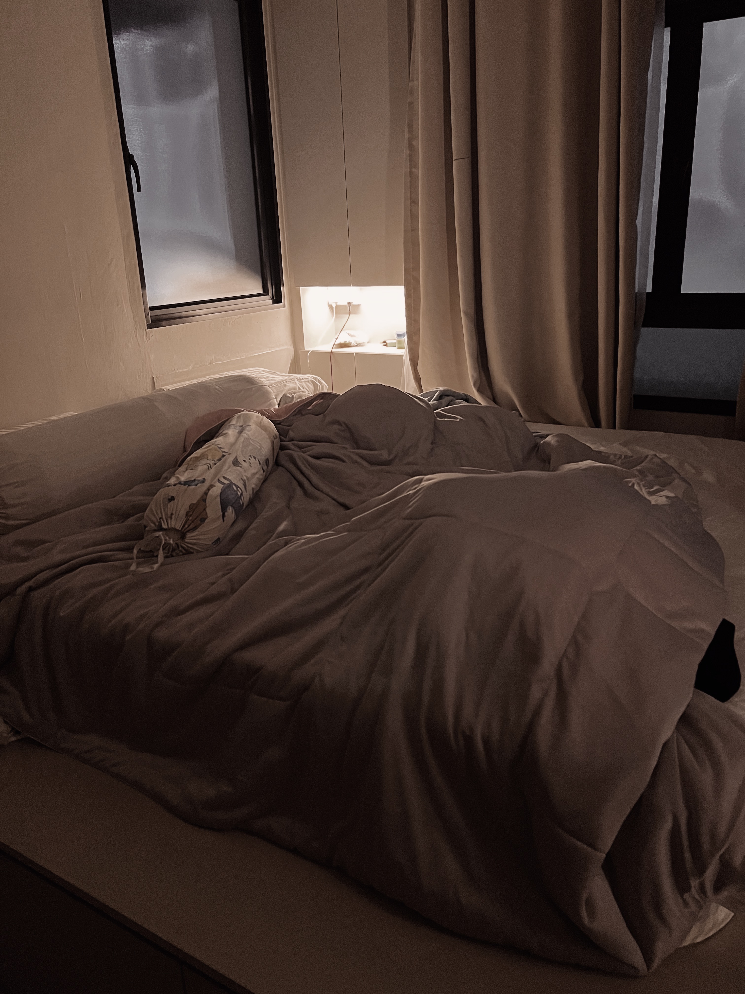 Master Bedroom: where we unwind, relax & reset  - dimly lit bedroom, cozy bed, person sleeping, beige curtains, soft