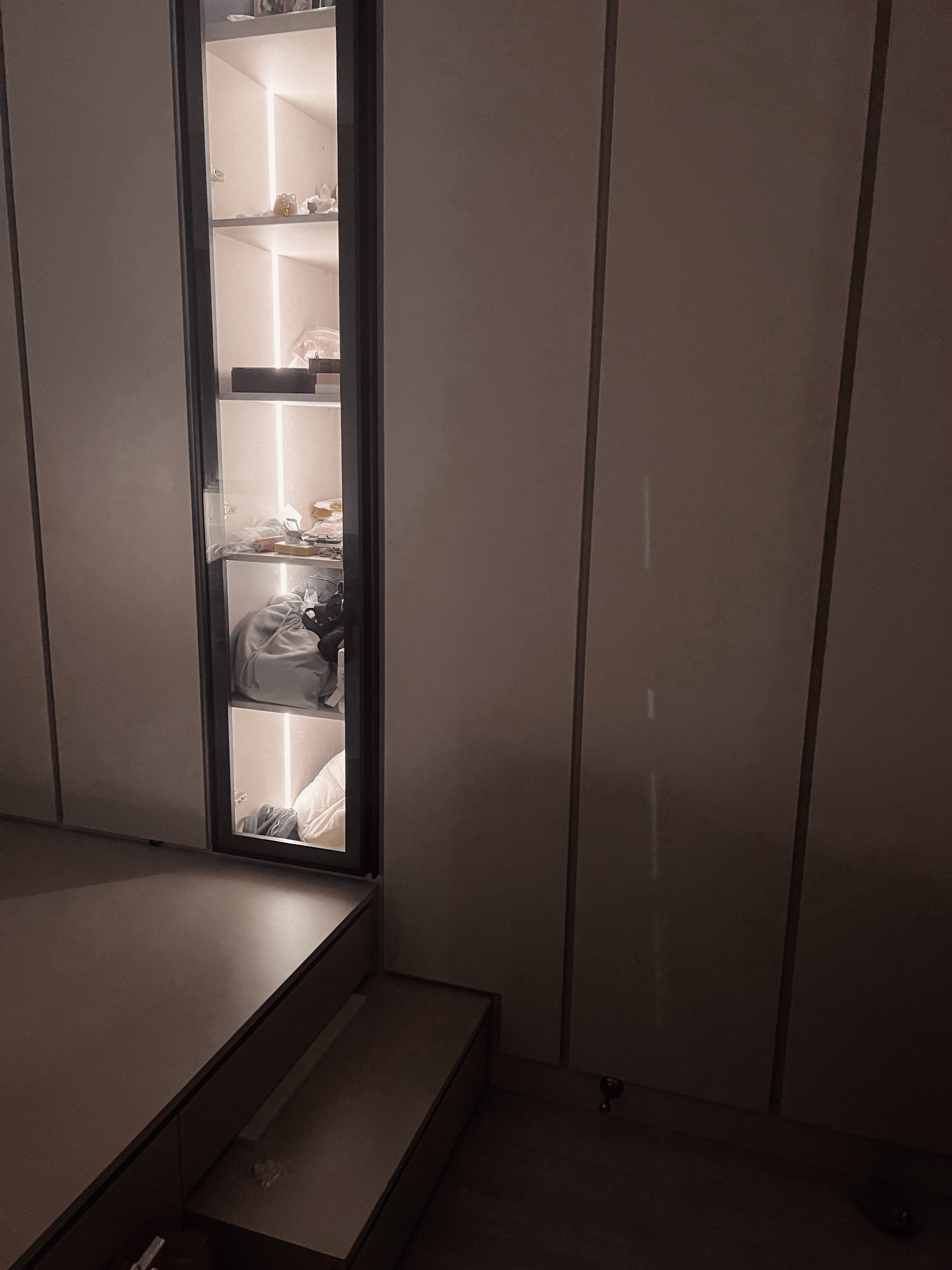 Master Bedroom: where we unwind, relax & reset  - Shelf with illuminated compartments, minimalist wardrobe, soft lighting