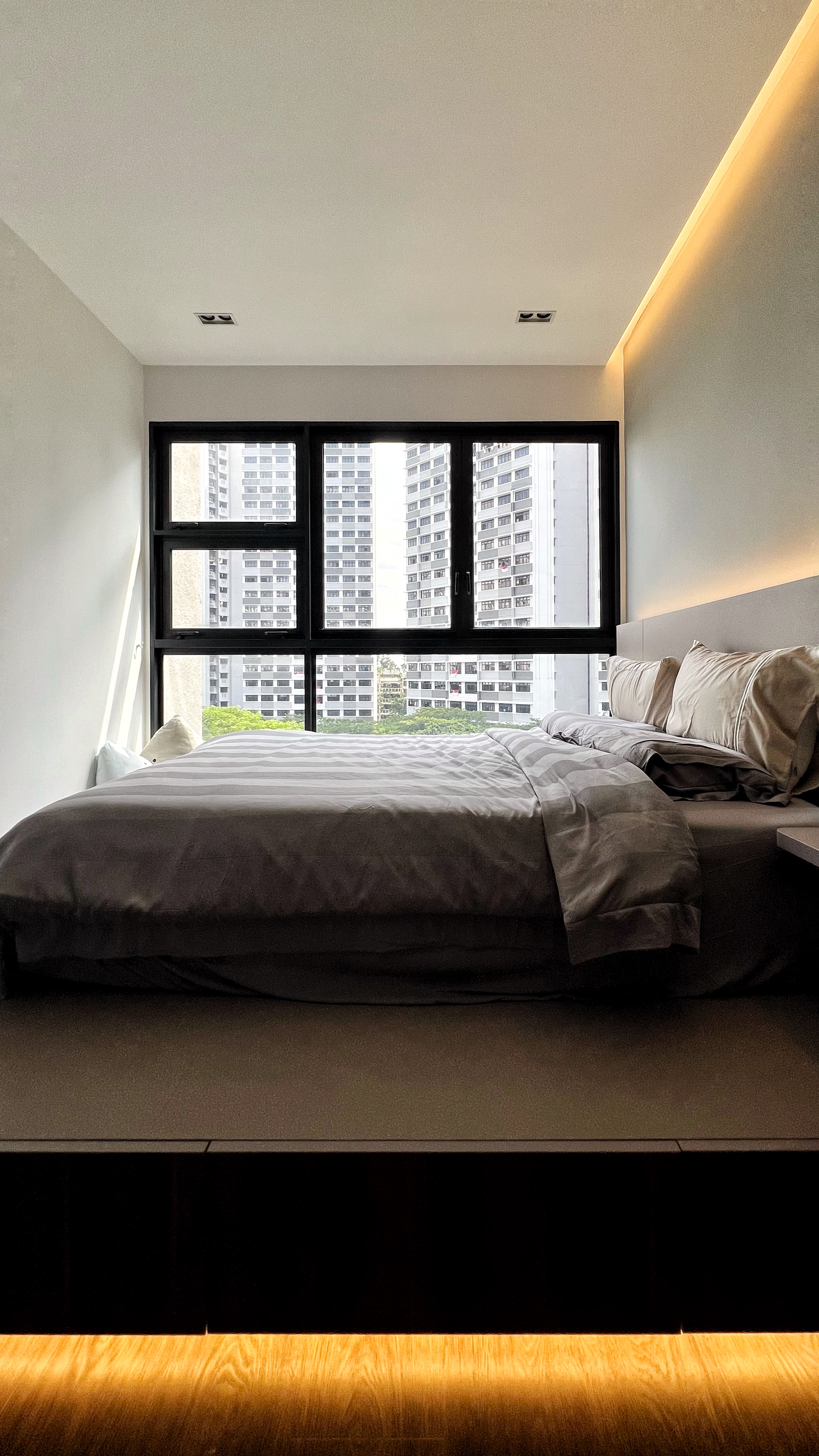 Unwind and Recharge: A Minimalist Yet Cosy Bedroom Retreat - Modern bedroom with large window, neutral color palette, neatly
