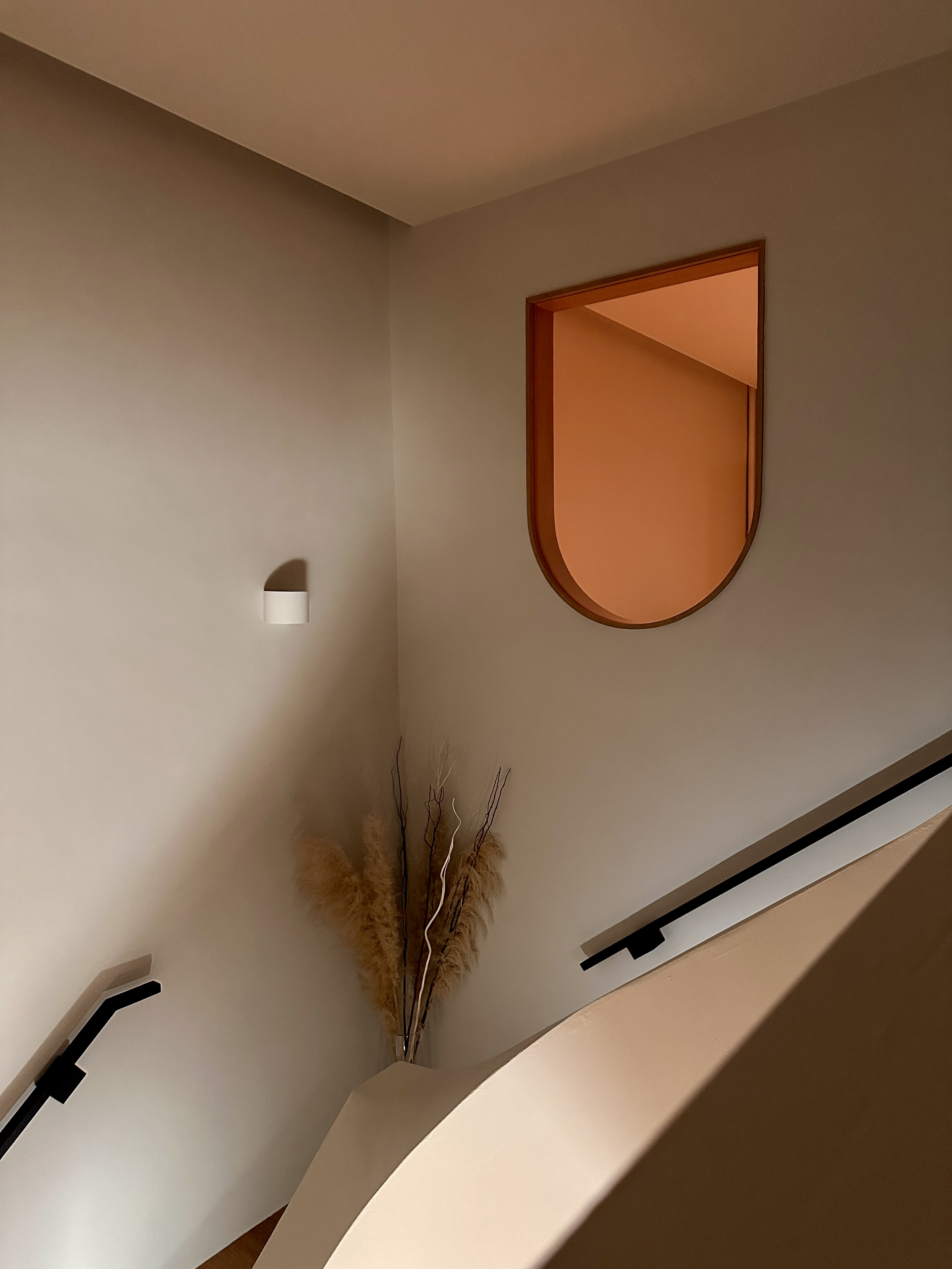 Calm | Stairways - Modern minimalist interior, soft lighting, neutral color palette, elegant staircase, sleek black handrail