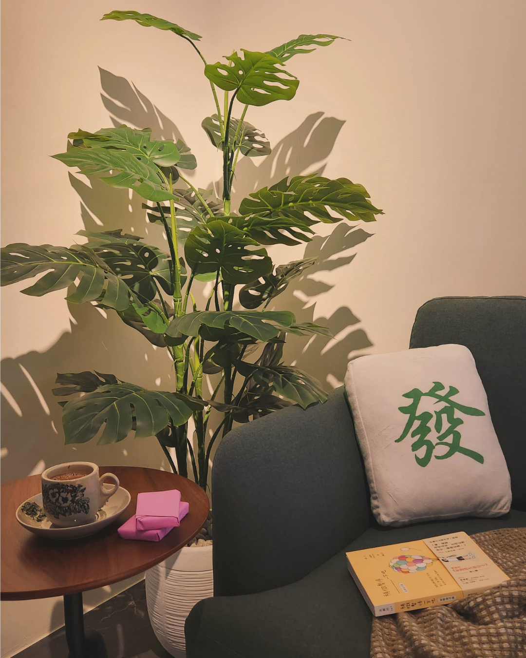 Cozy Up for Movie Nights: The Charm of Full-Height Glass Doors - Green potted plant, cozy armchair, soft lighting, indoor