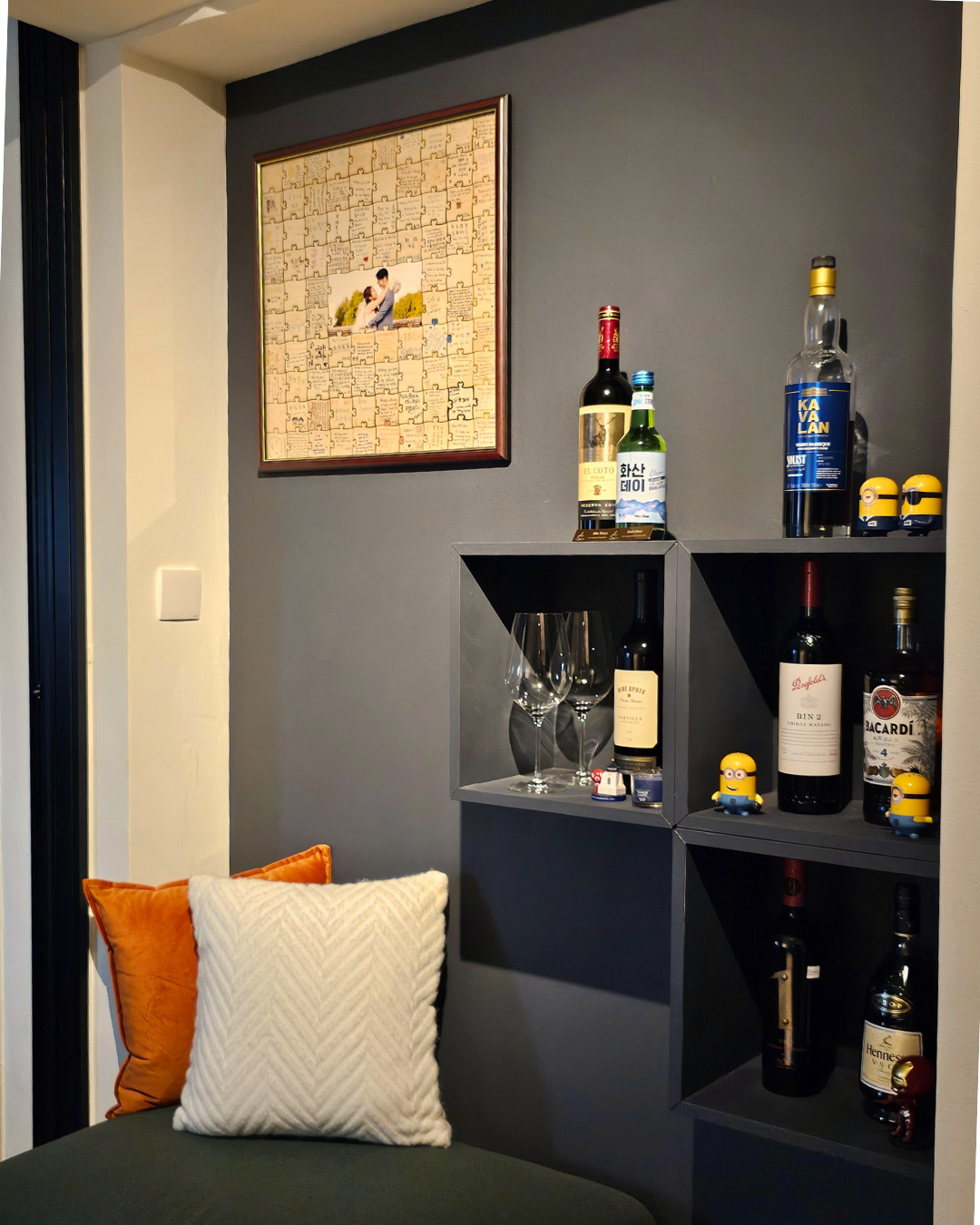 Cozy Up for Movie Nights: The Charm of Full-Height Glass Doors - Jumbo wine bottles, small yellow figurines, wine glasses