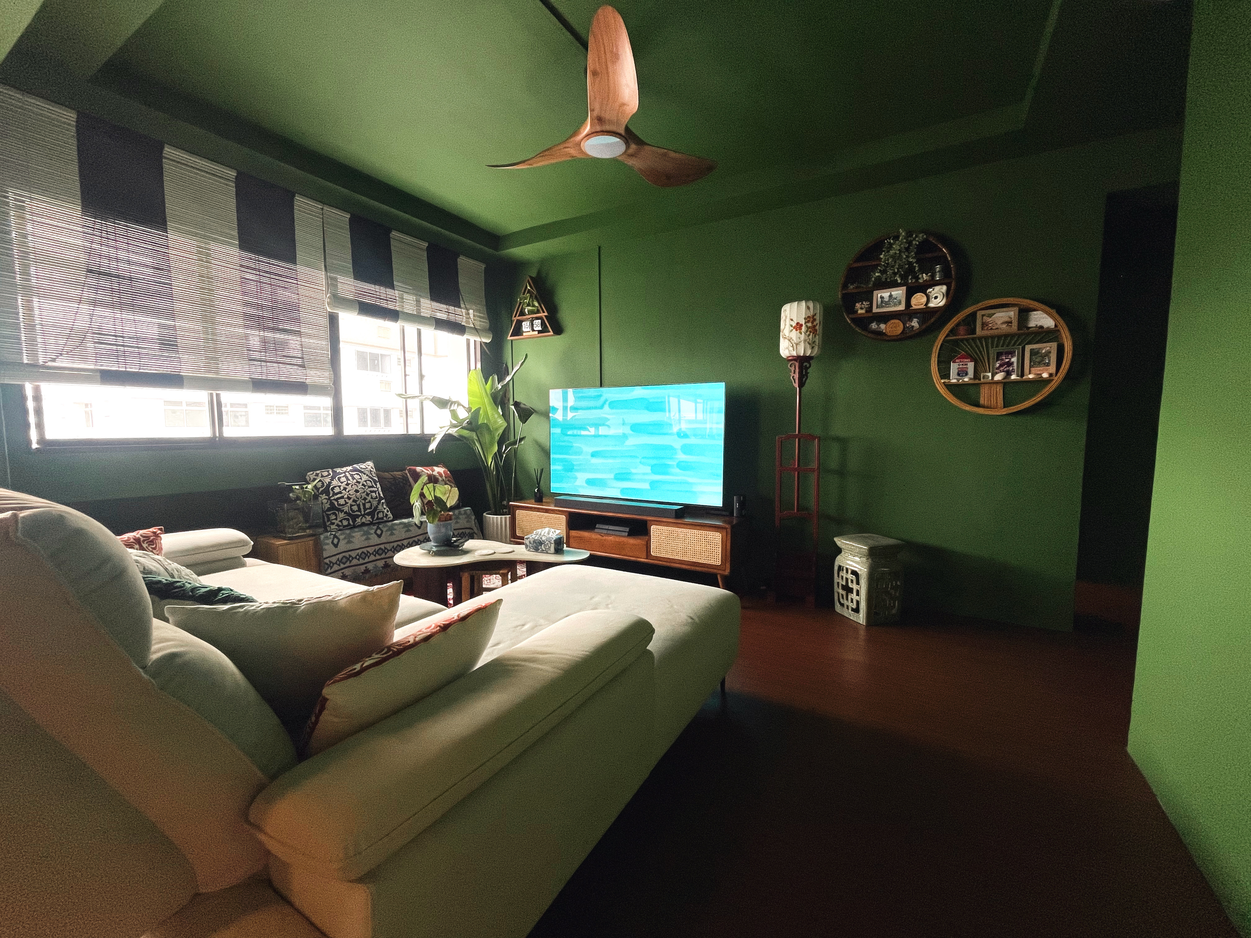 Curated Mix & Match: Our Living Room's Perfect Blend - Green living room, cozy seating, modern design, large window, striped