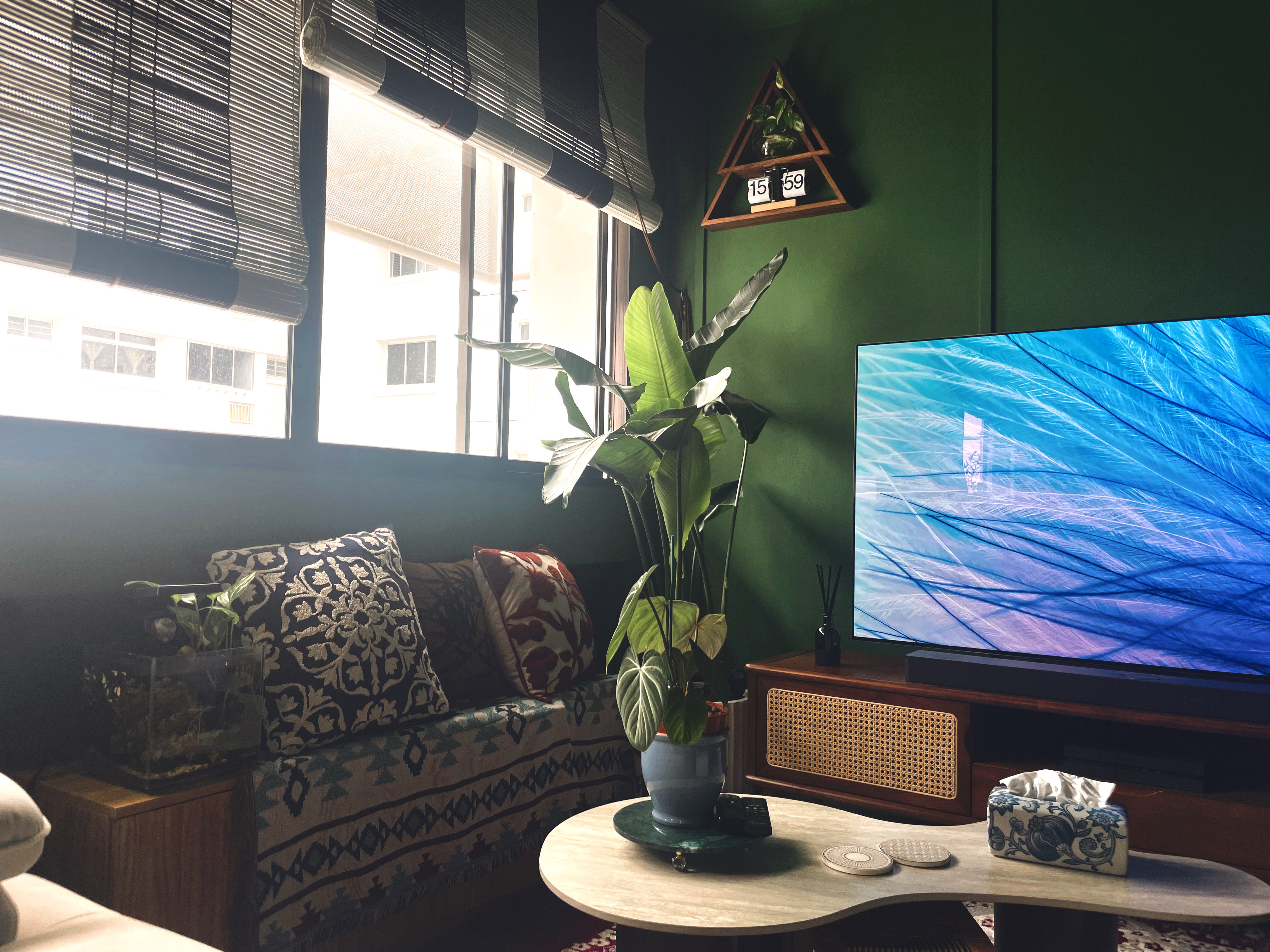 Curated Mix & Match: Our Living Room's Perfect Blend - Green wall, modern living room, large window, blue screen TV