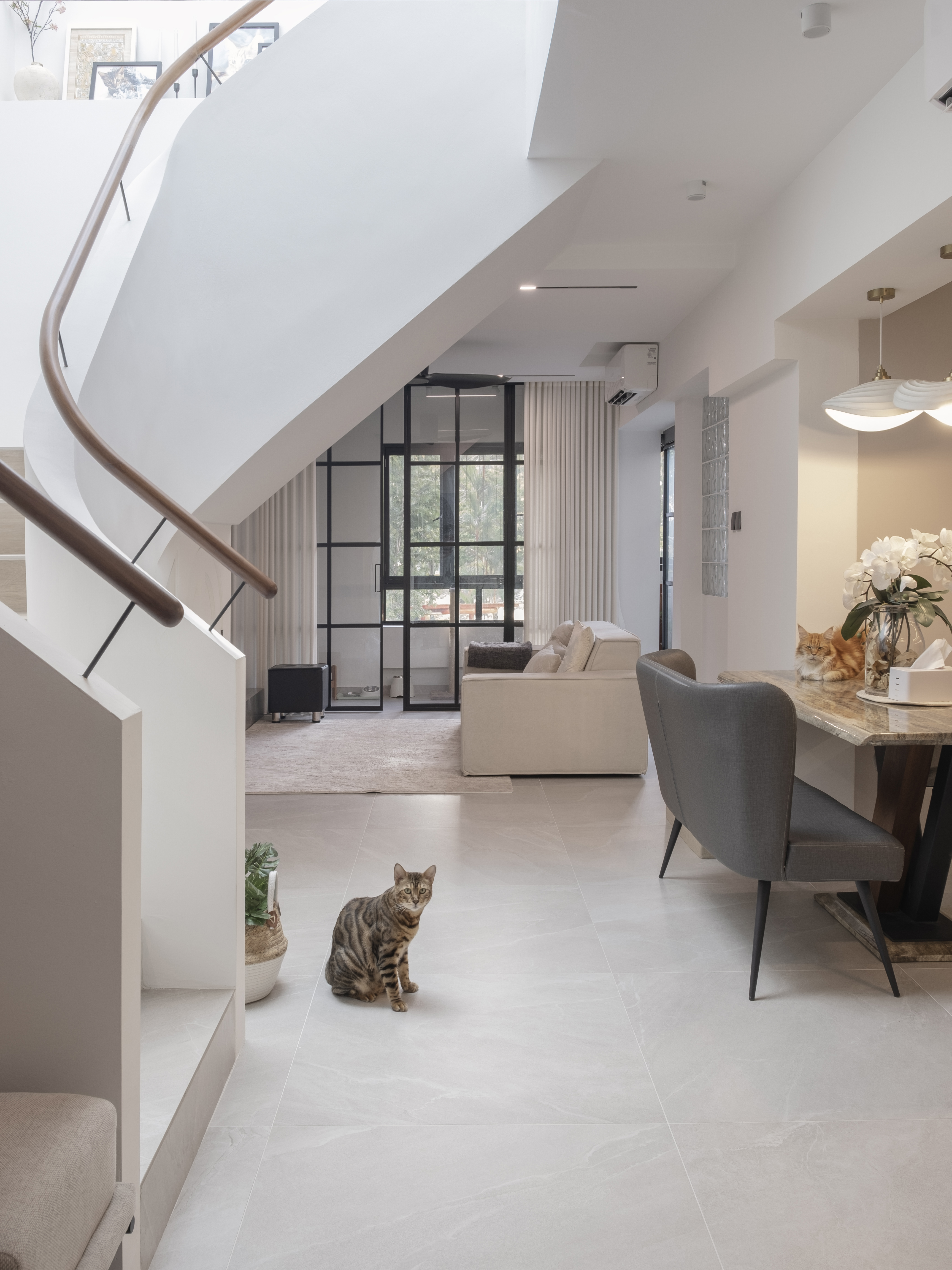 Inside a 300k Reno Modern Gallery-Inspired Maisonette - Modern minimalist living room with elegant staircase, stylish dining