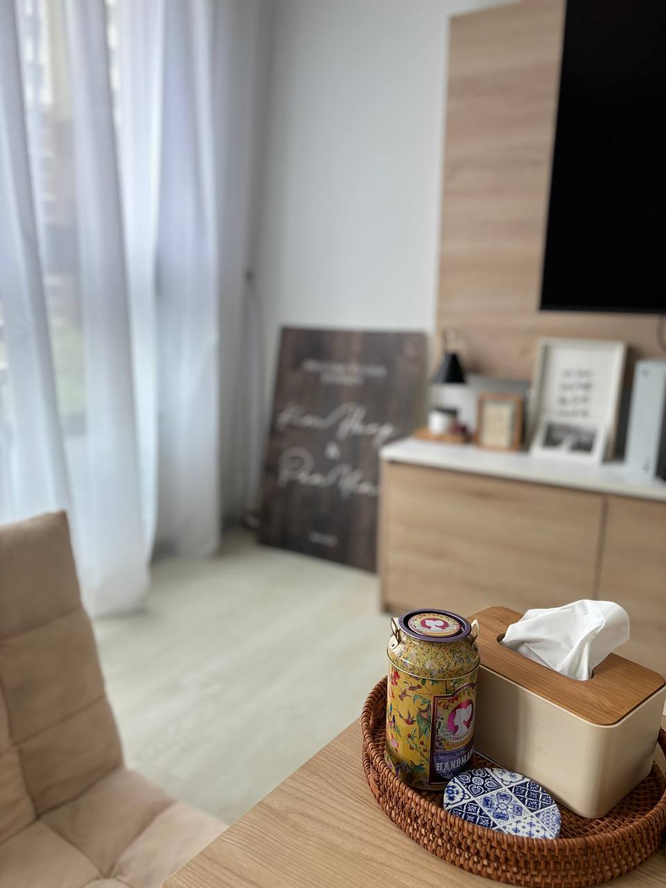 From Day to Night: Japandi Living Space With Collectables - Cup with tea, tissue box, decorative tea set, wooden table