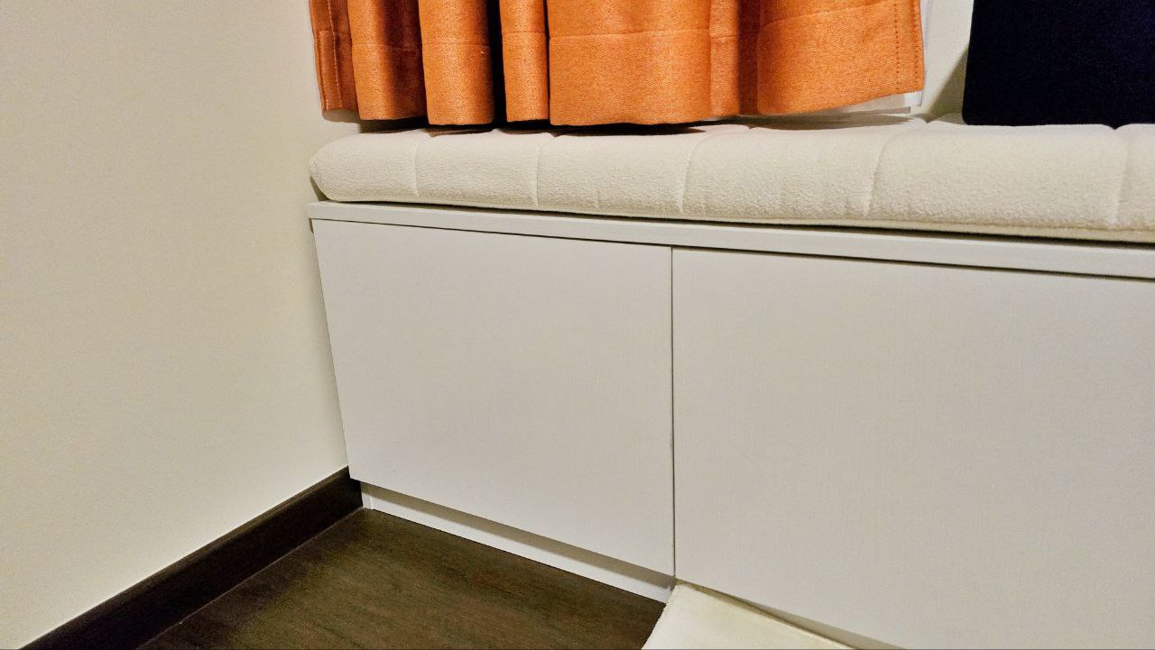 Transforming Our Living Room : Minimalist and Smart Storage Solution - White cabinetry, orange curtains, soft beige cushion