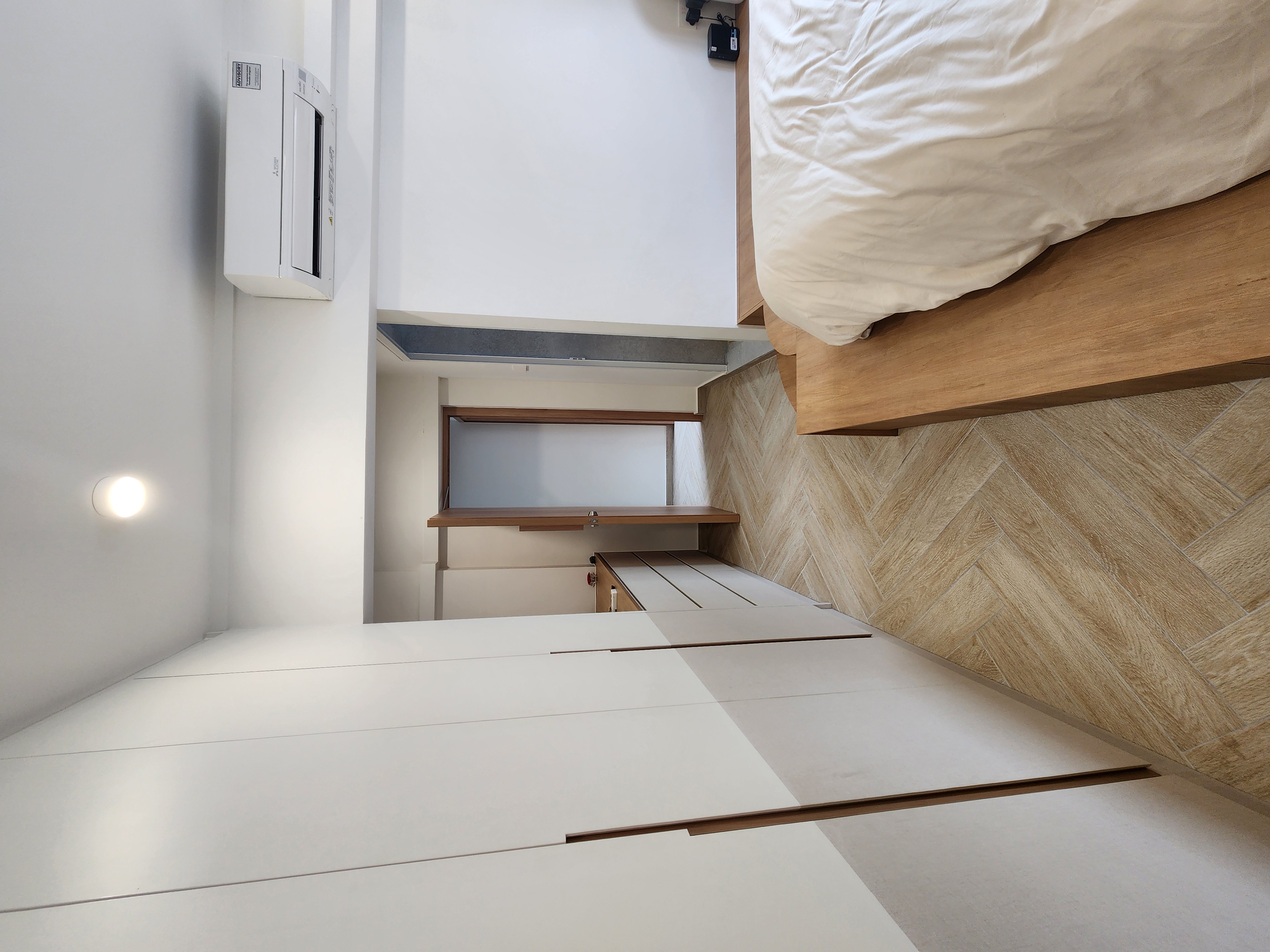 Unfold $8k Carpentry For our Master - Modern minimalist bedroom, white walls, wooden flooring, herringbone pattern, built-in