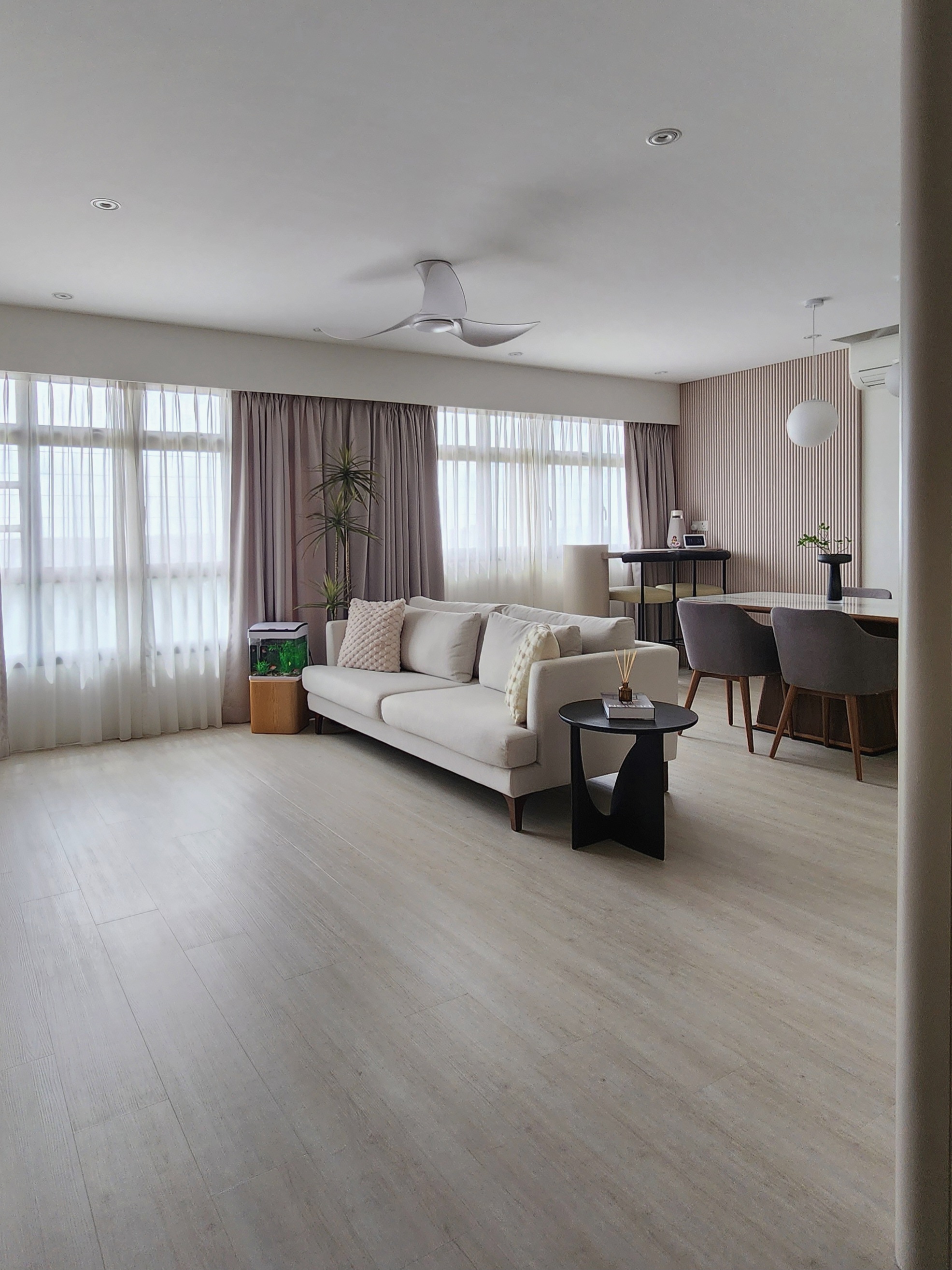 Our Living Area: A Reflection Of Our Innerselves  - Light-colored, modern living room with beige sofa, wooden floor, large