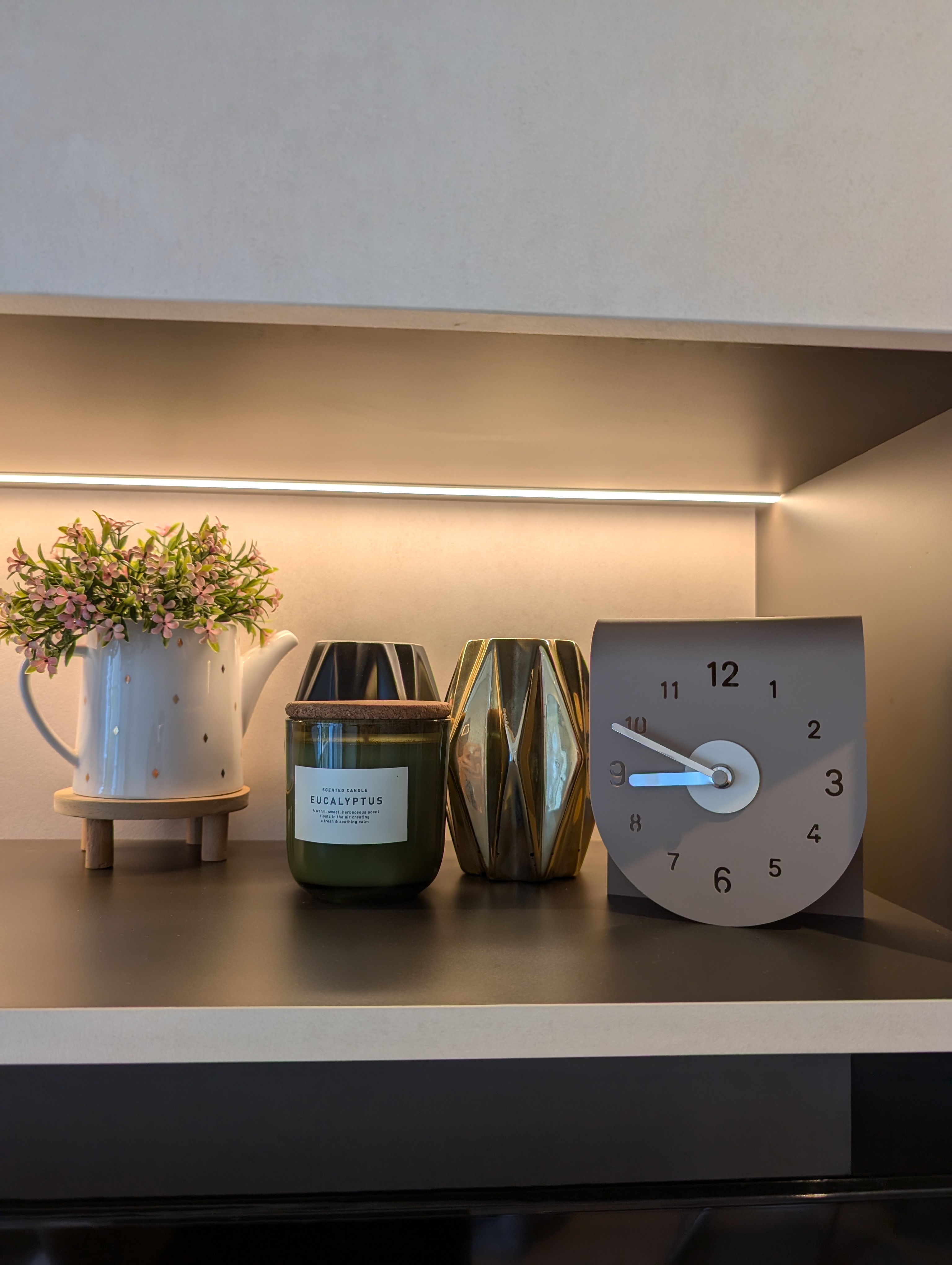 Where is the mess? We hid it! - Scented candle, scented candle labeled "Eucalyptus, " white pitcher with pink flowers