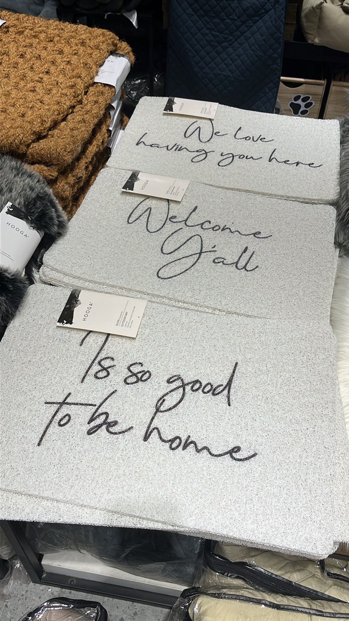 Turning a Small Entryway Into a Functional Space Without Built-ins - Faux fur throw pillows, "We love having you here" tags