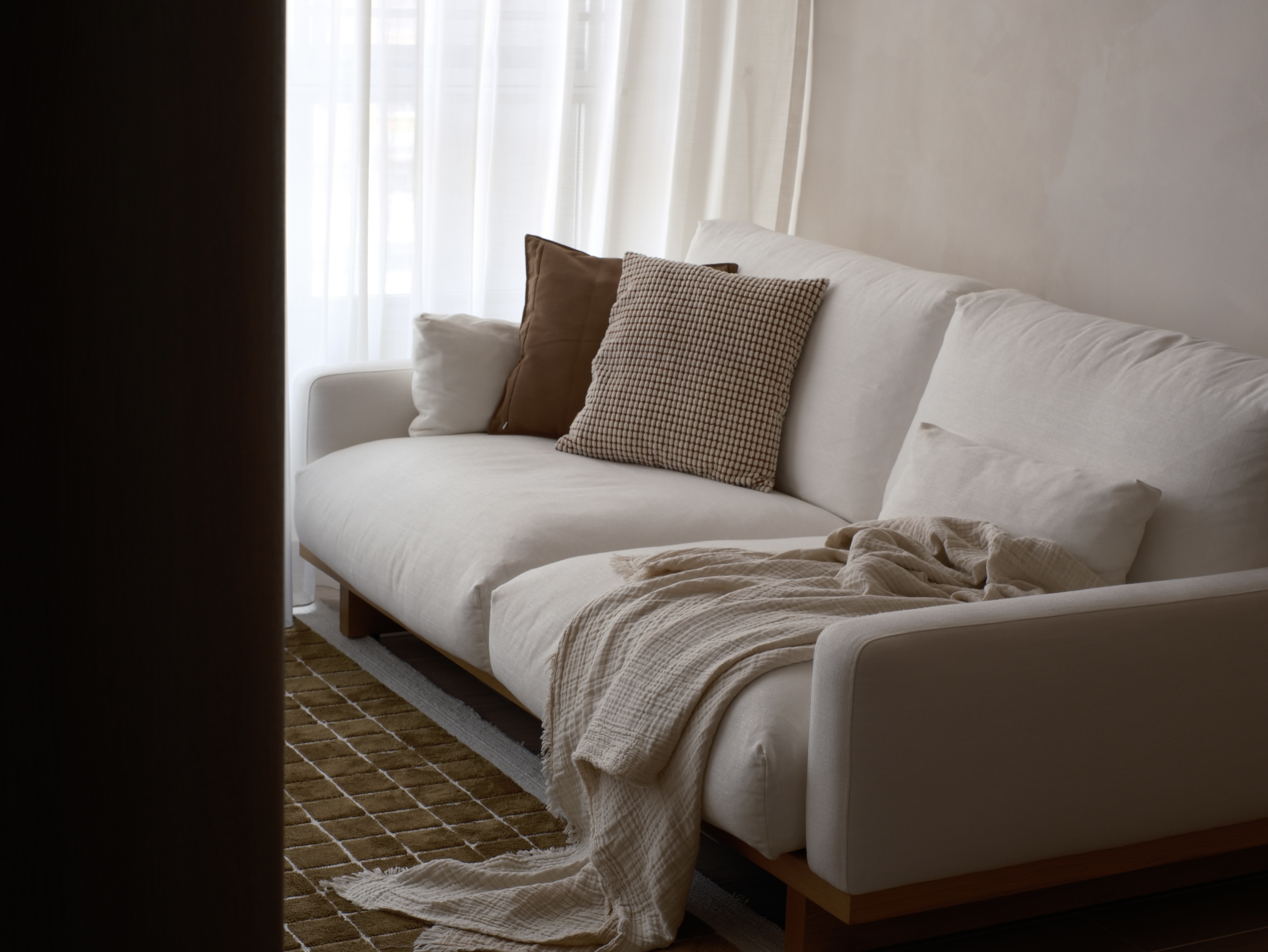 Cozy Living Room Ambiance with Textures and Lighting - No Built Ins! - White sofa, beige cushions, brown patterned pillow