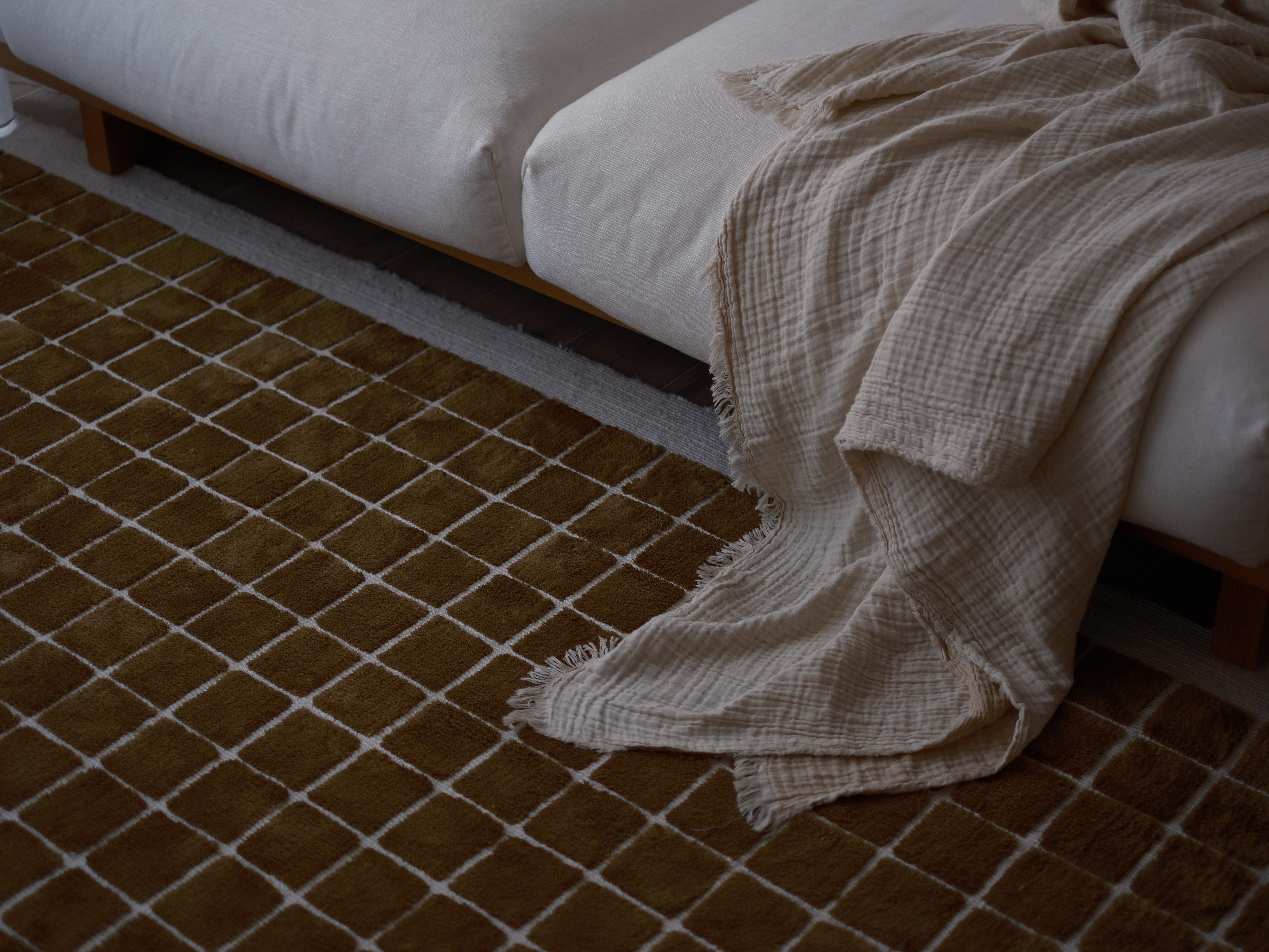 Cozy Living Room Ambiance with Textures and Lighting - No Built Ins! - White bed frame, beige blanket, brown checkered rug