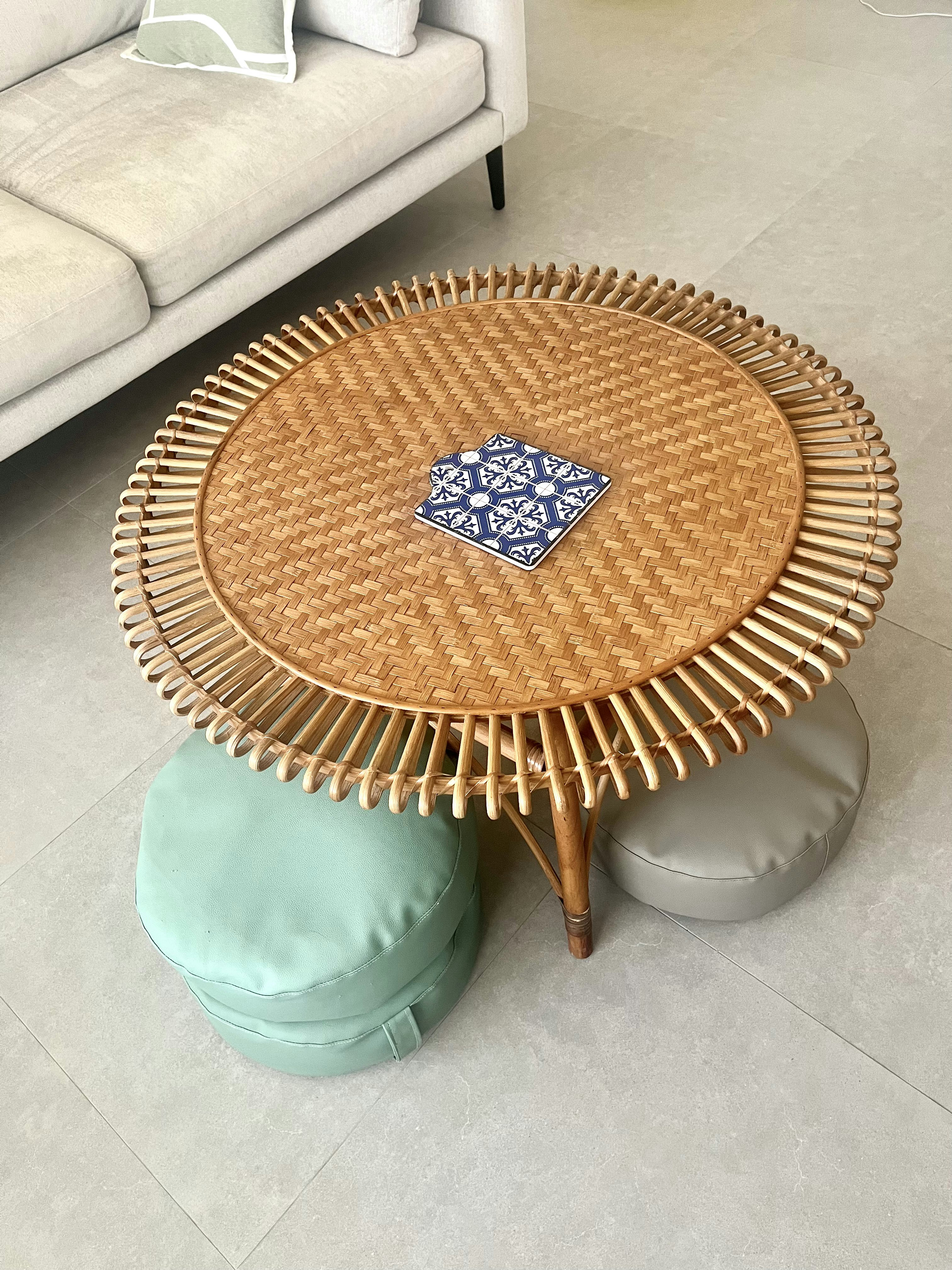Blending secondhand and contemporary pieces in our Living Room - Woven coffee table, light gray sofa, blue and white