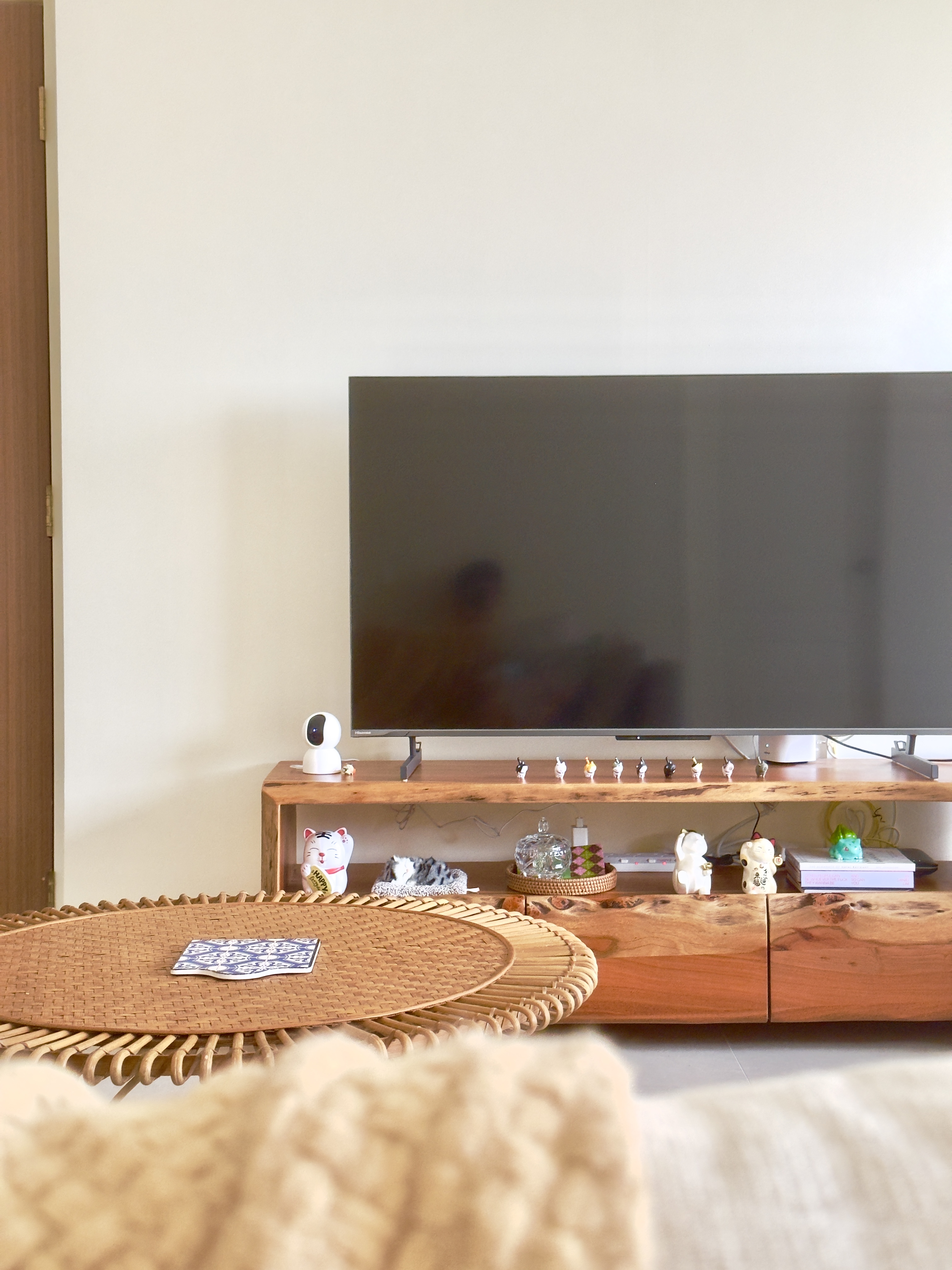 Blending secondhand and contemporary pieces in our Living Room - Wooden TV stand, minimalist decor, small white robot, cat