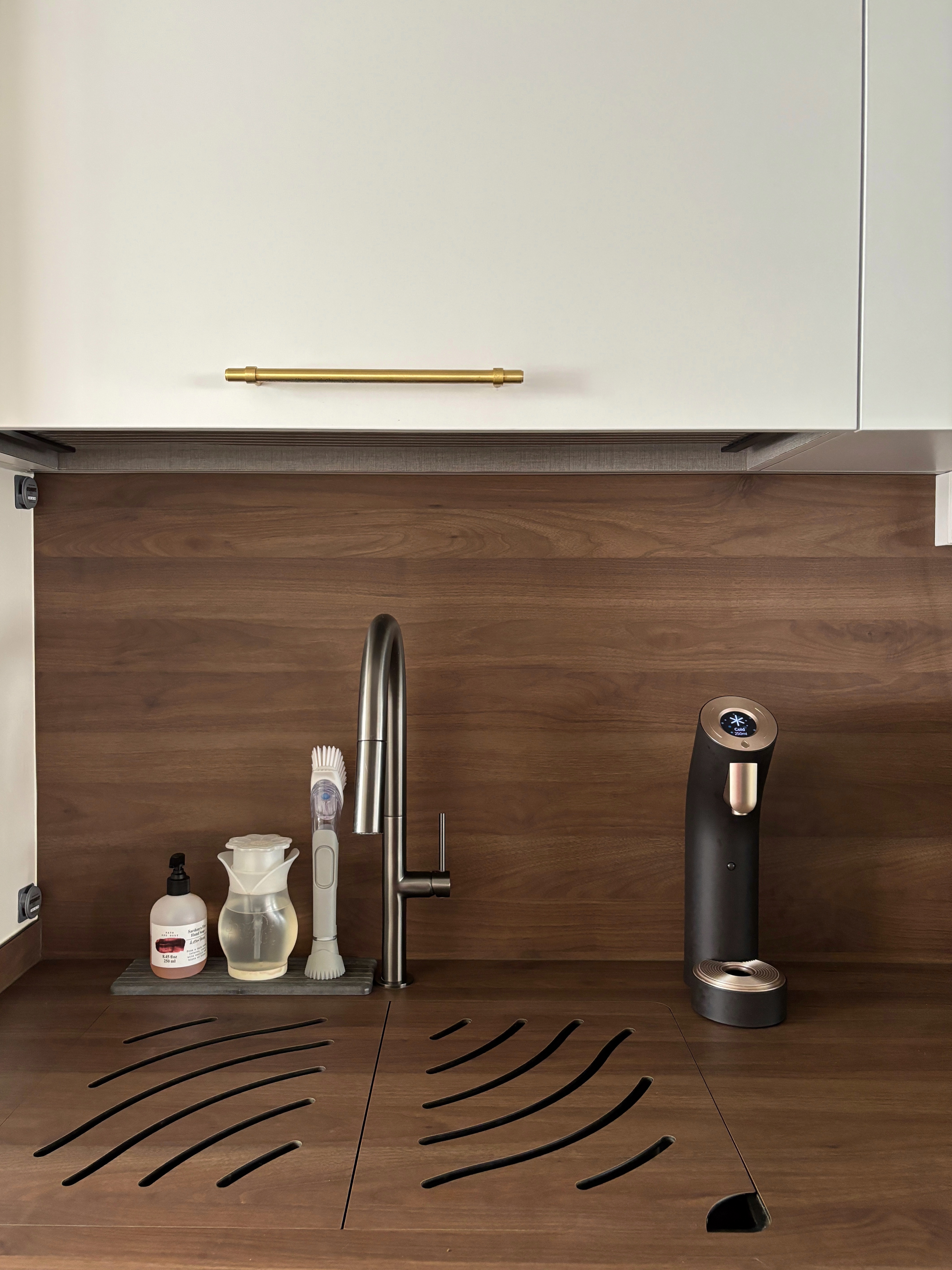 Our Best Home Investment for Staying Hydrated - Wooden kitchen countertop, modern faucet, black kitchen appliance, white