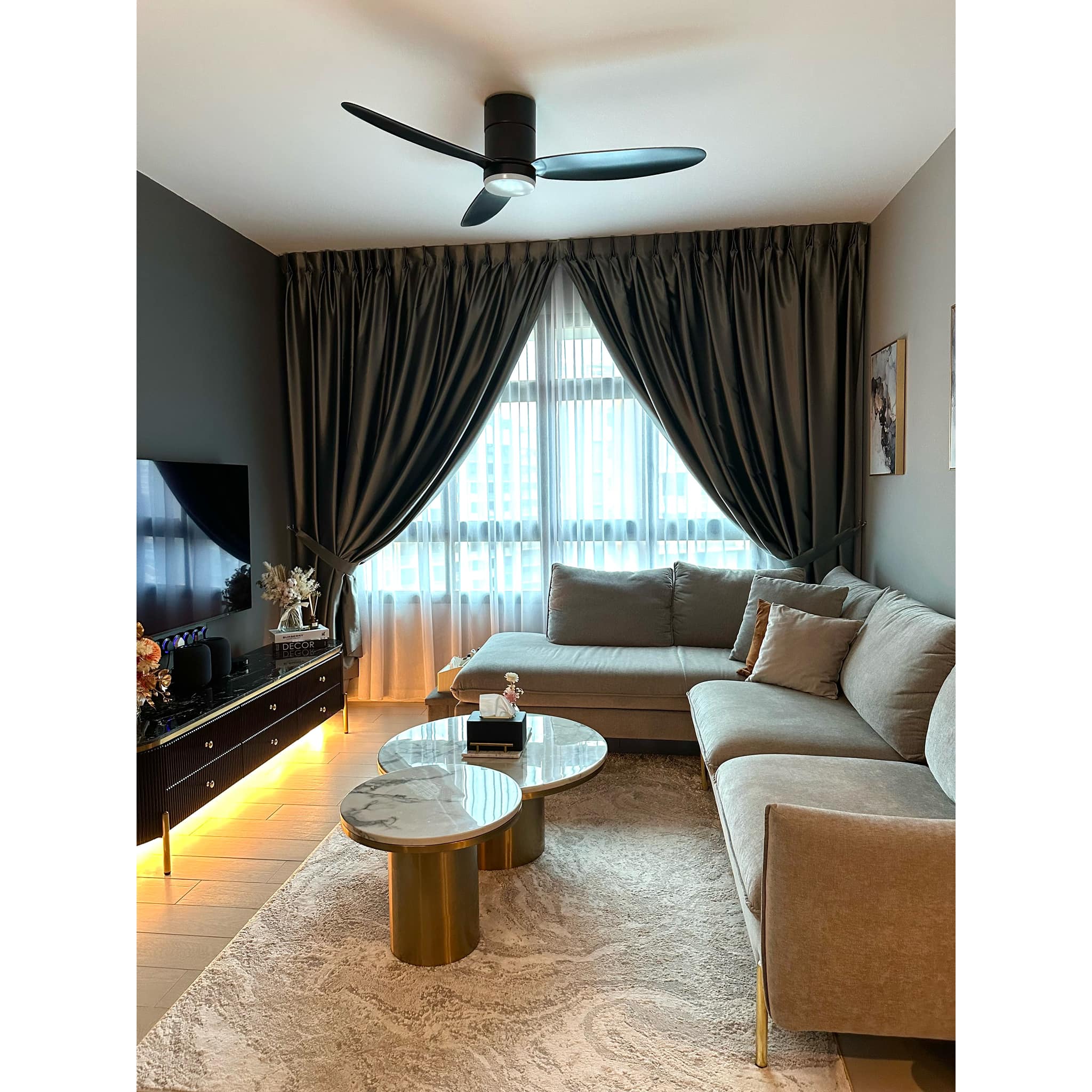 Creating A Modern-luxe Living Room Through Perfect Furniture Pairing - Modern living room with gray sofa, beige rug, gold