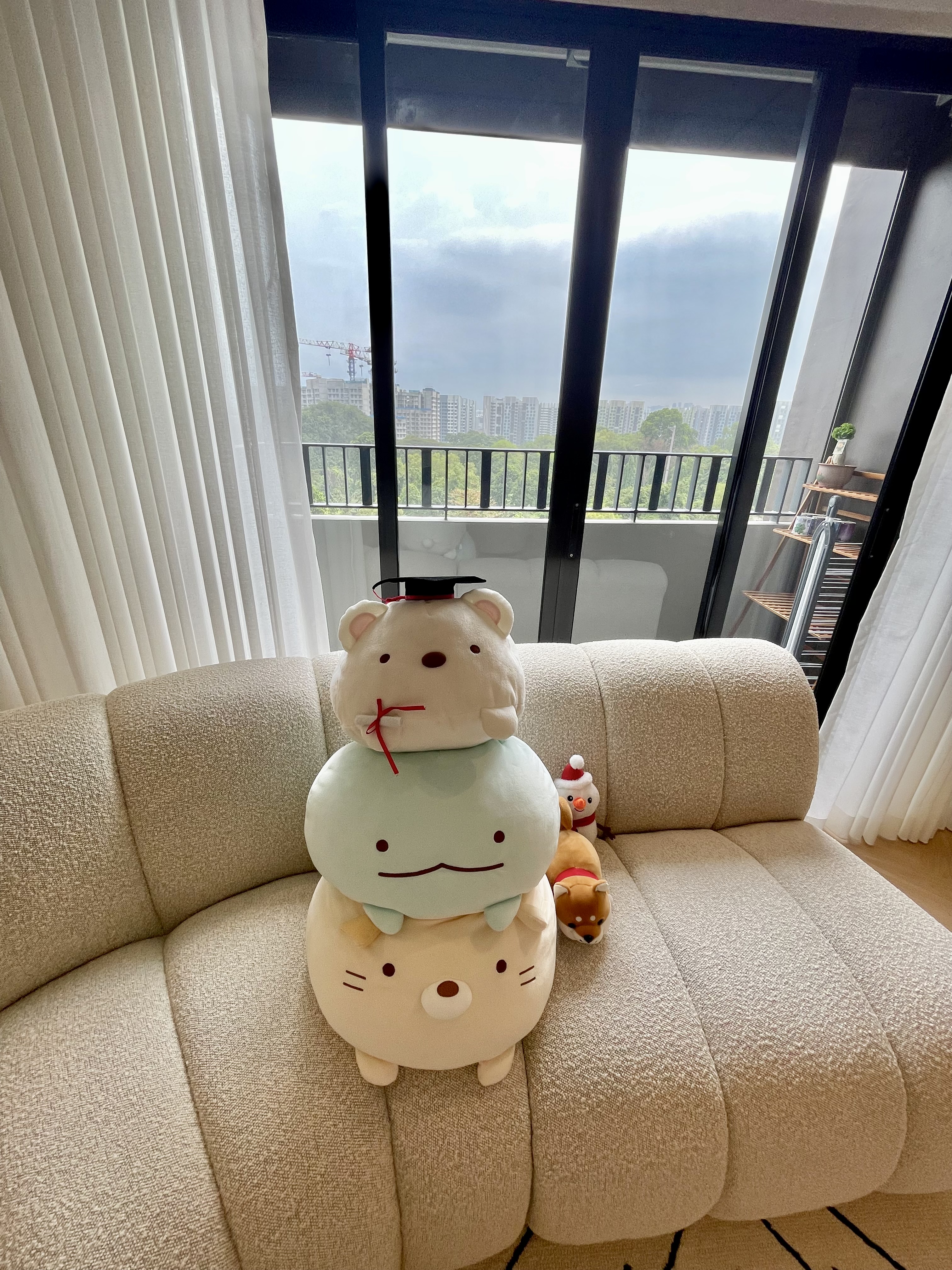 Our Japandi Lounge: A Blend Of Limewash Walls And Curved Fluted Panels - Cute plush toys on beige sofa, large teddy bear with