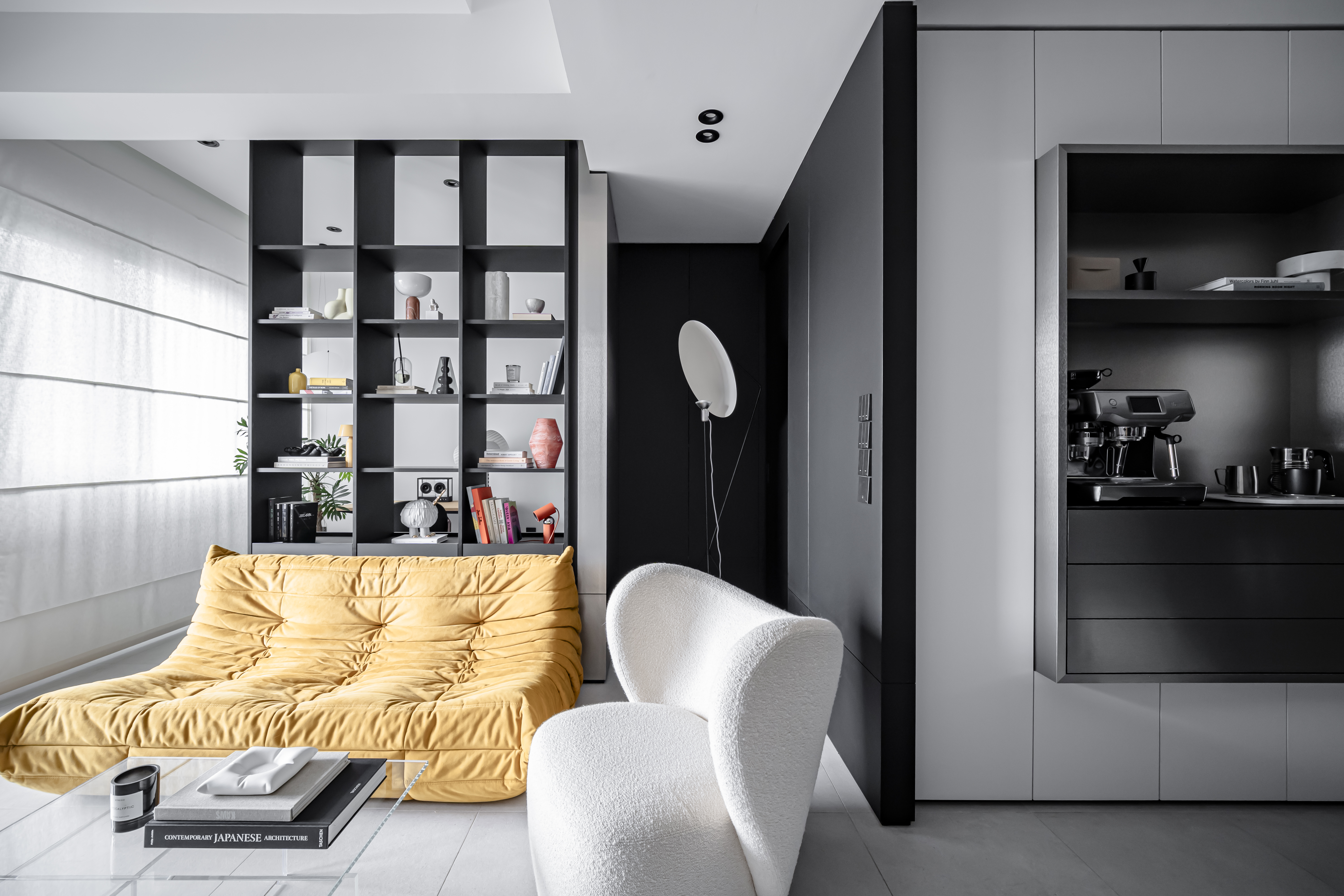 Our Living Room: A Gallery of Designer Pieces  - Modern minimalist living room, sleek black bookshelf, yellow tufted sofa