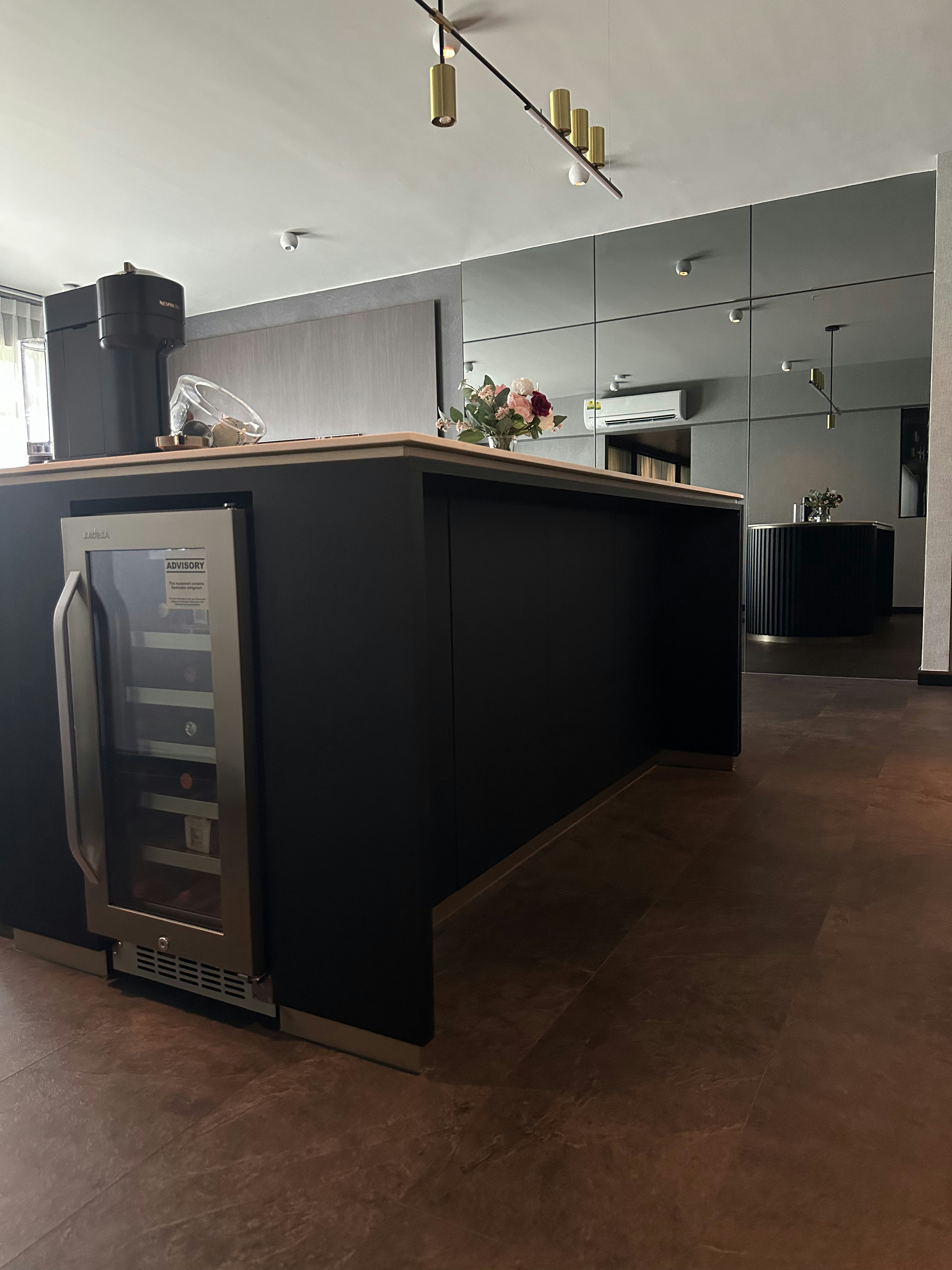 Living Room’s Centerpiece: Custom Island with Hidden Wine Chiller - modern kitchen, sleek design, minimalist decor, black