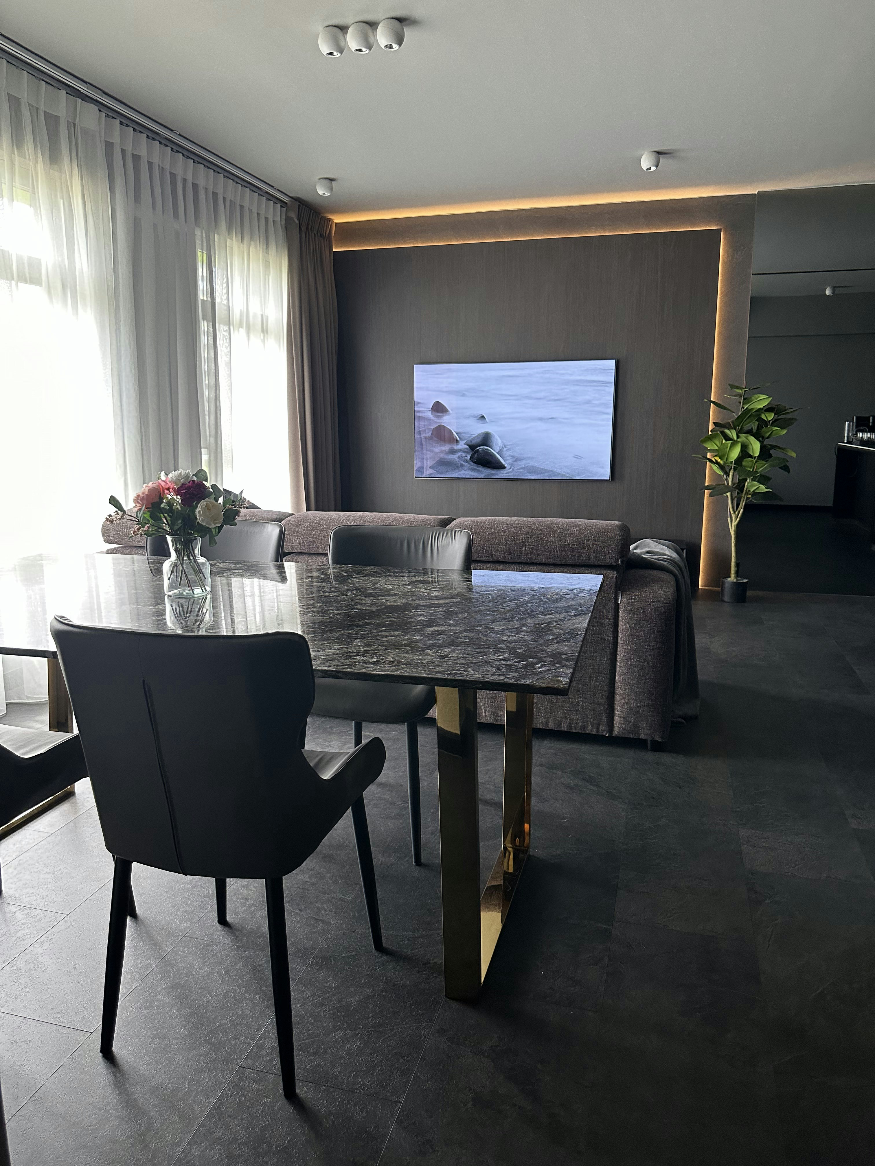 Living Room’s Centerpiece: Custom Island with Hidden Wine Chiller - Modern living room, sleek furniture, dark marble dining