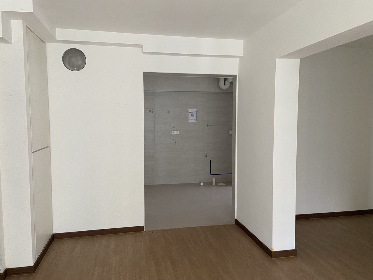 Spacious Entryway with a blend of Coastal Farmhouse - Modern minimalist bathroom, clean white walls, wooden flooring