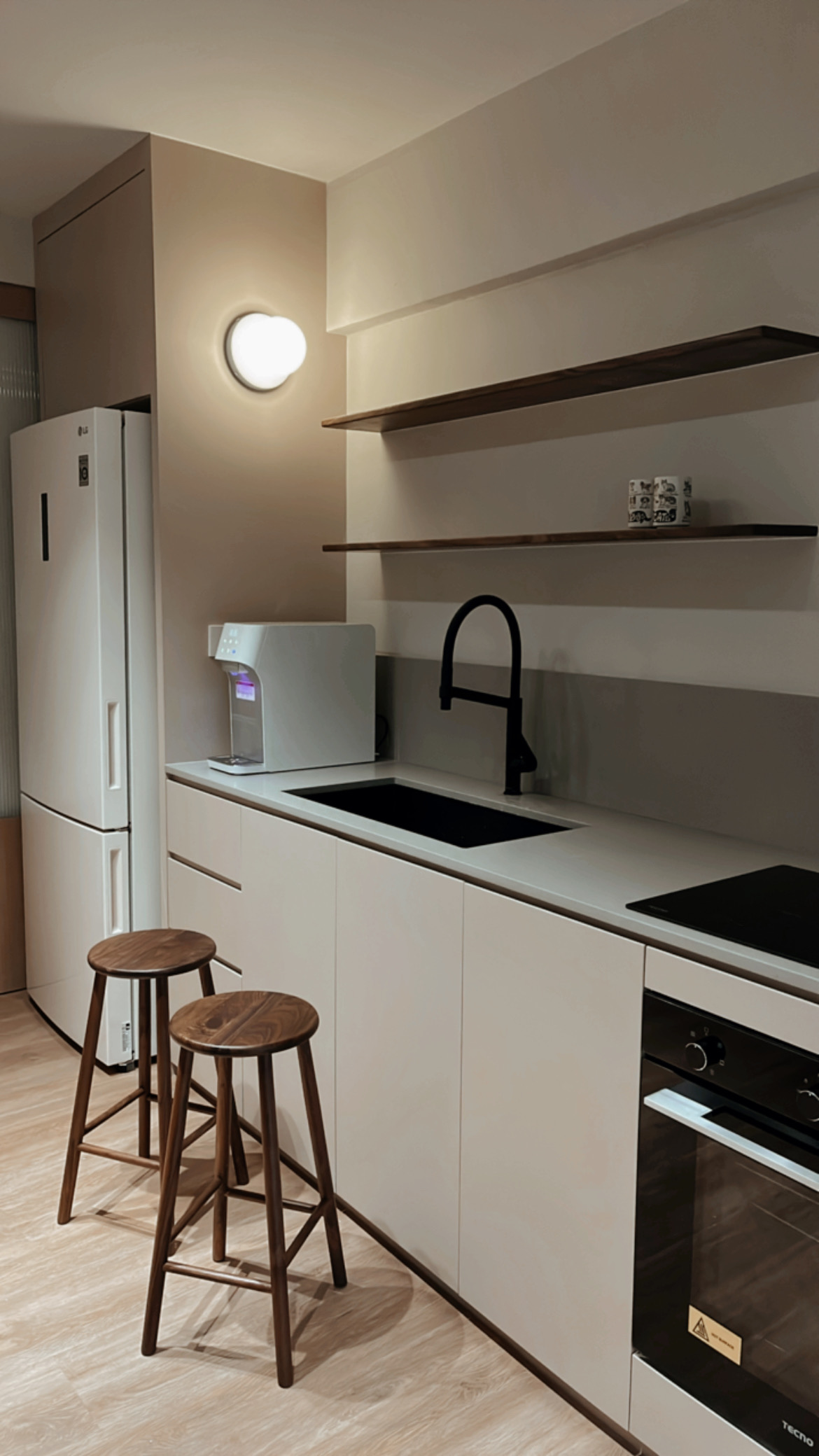 Lighting Tips: Creating Warmth and Style with Lighting - Modern kitchen with sleek design, white refrigerator, built-in oven