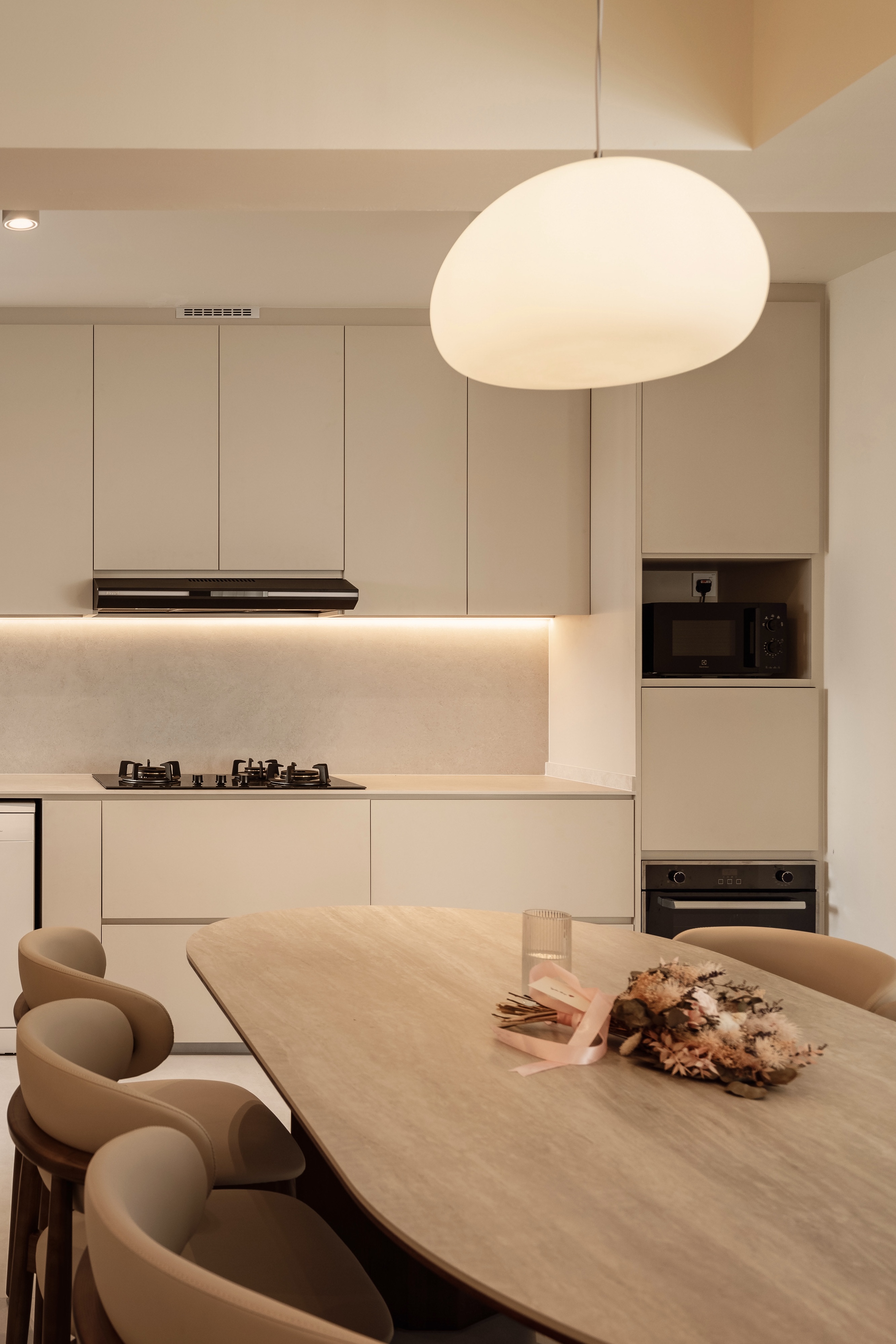 Heart Of The Home: Creating My Dream Cream Kitchen - Modern kitchen with beige cabinets, sleek black range hood, minimalist
