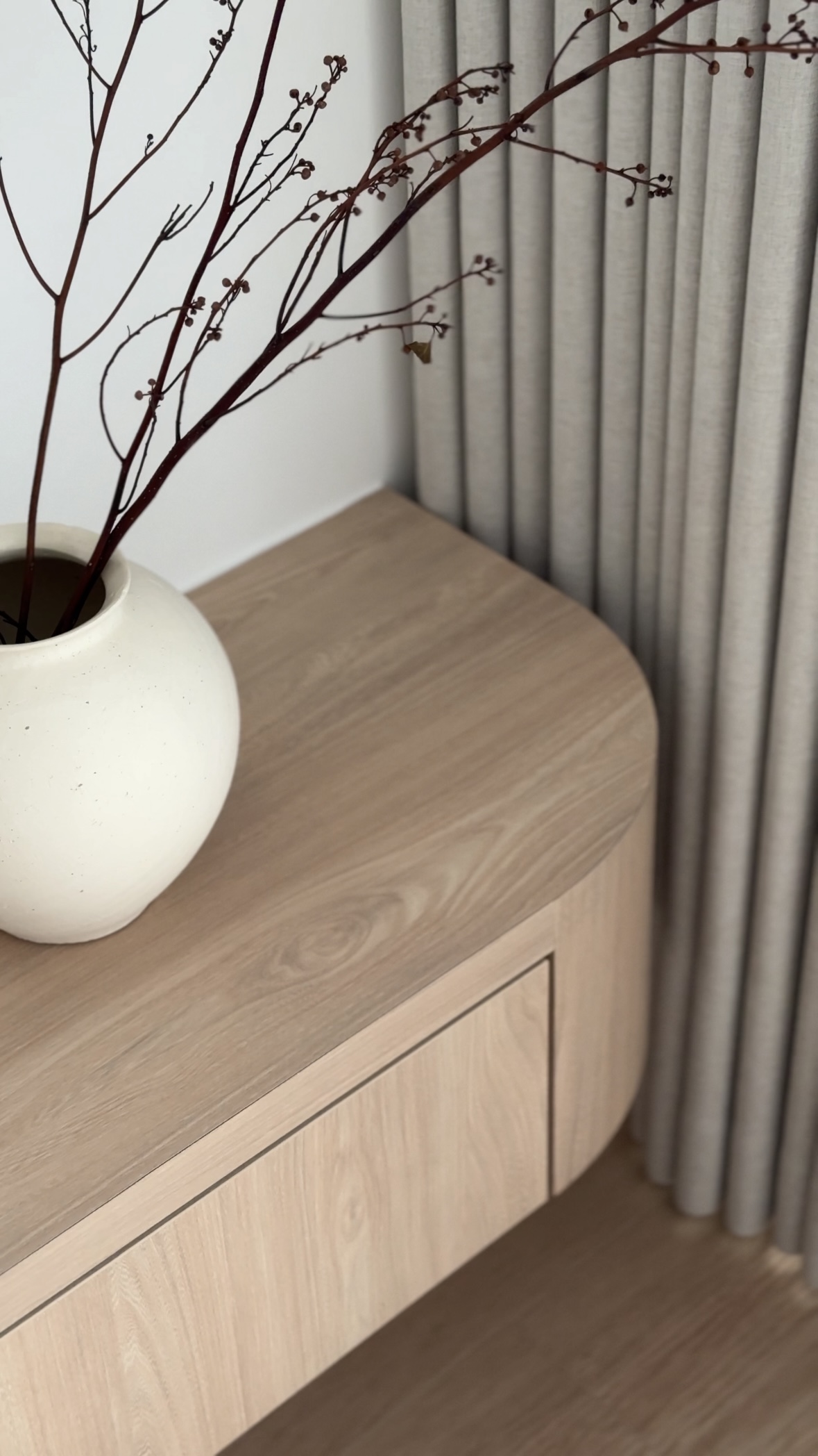 Living Room: Where the Homebodies Gather - vase, branch, dried, twig, small buds, light wood, curved surface, minimalist