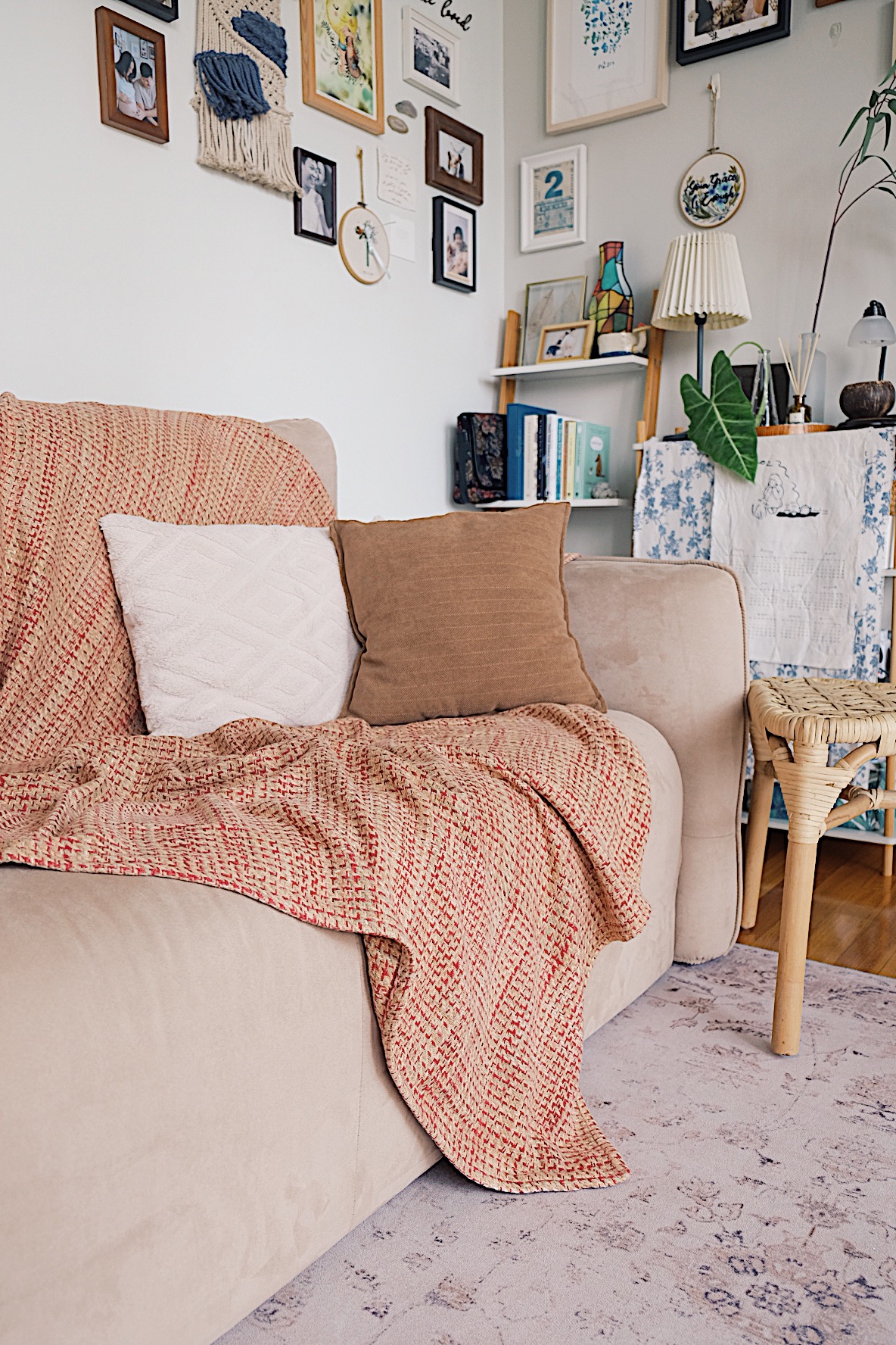 Styling gallery walls filled with memories in our Living Room (+TIPS) - Cream sofa, beige cushions, red and white patterned
